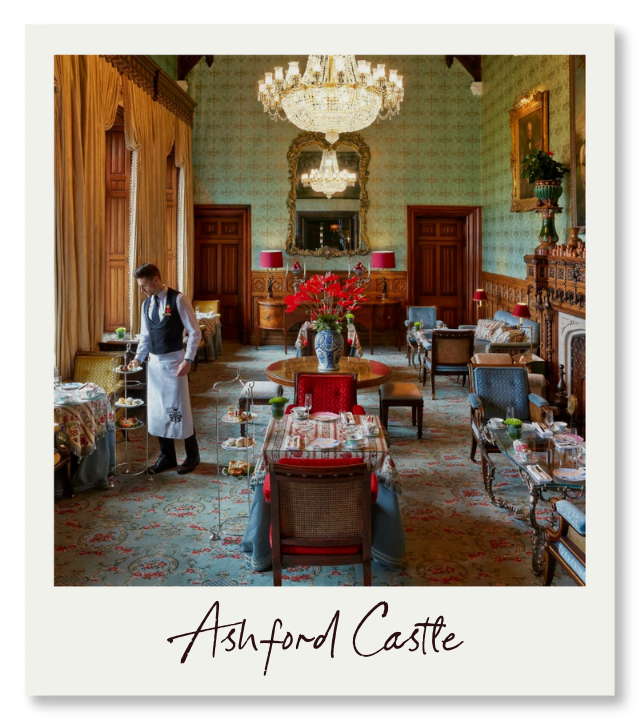 Ashford Castle In an elegant green sitting room at Ashford Castle, a butler in formal attire prepares afternoon tea beside tall windows overlooking the estate grounds—the kind of service that has made this Ireland's most legendary castle hotel.