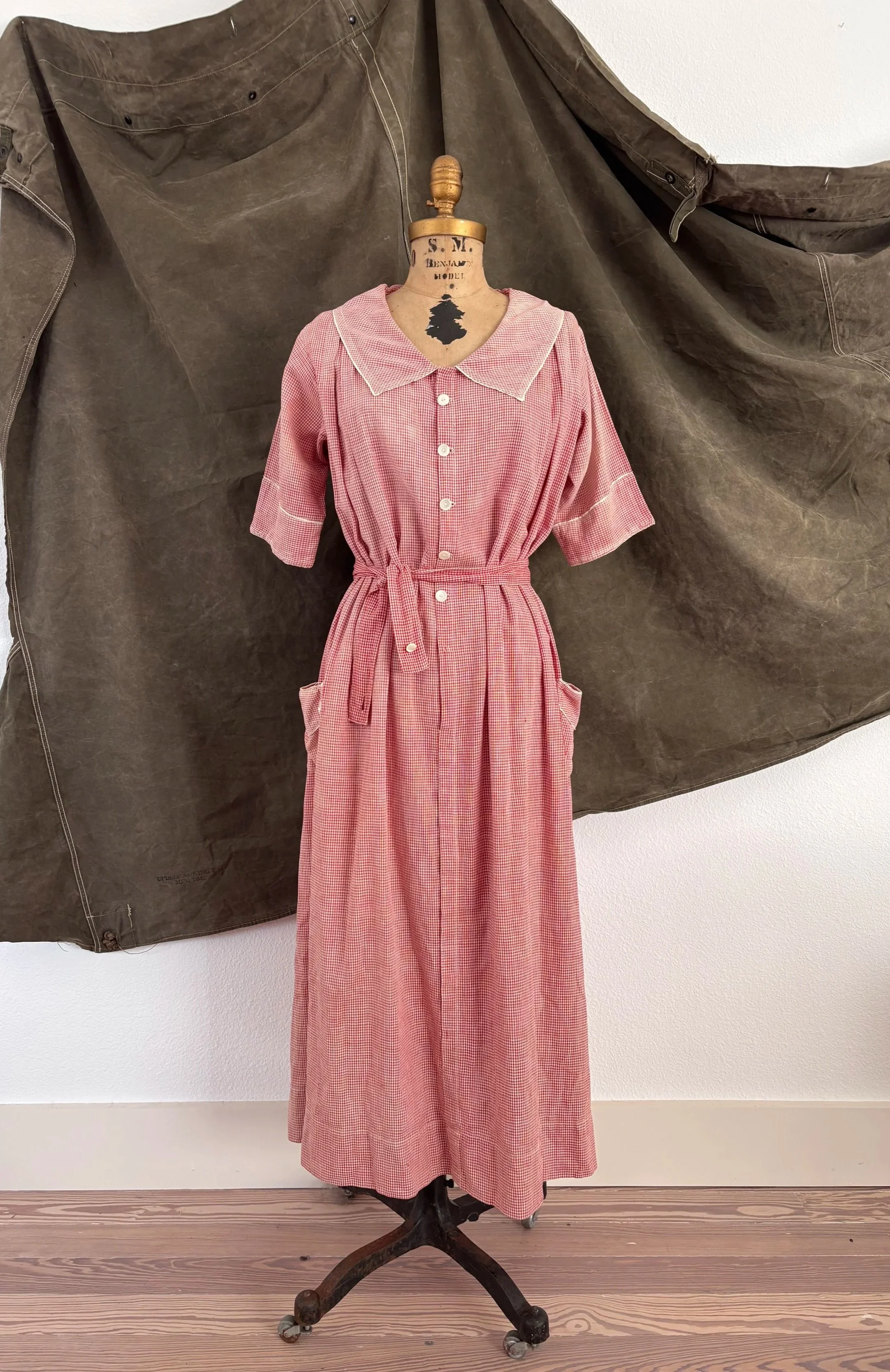 Front view of 1940s strawberry gingham house dress on dress form