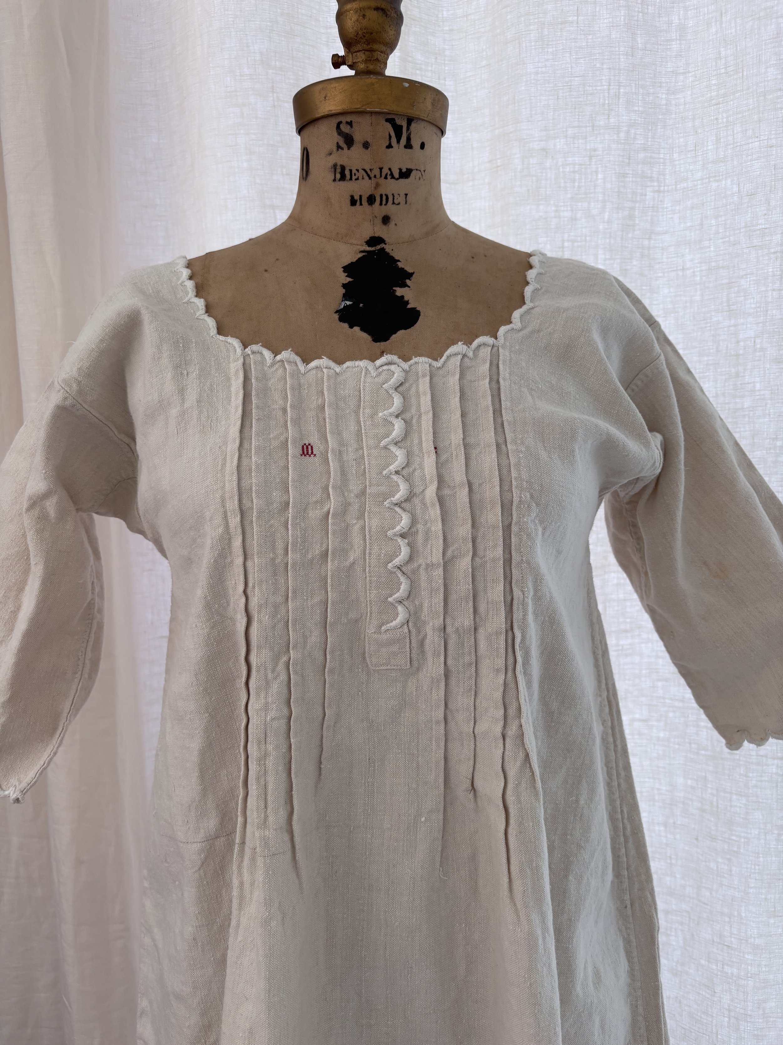 Close-up of pintucked front bodice and "M.L." monogram on antique French linen dress