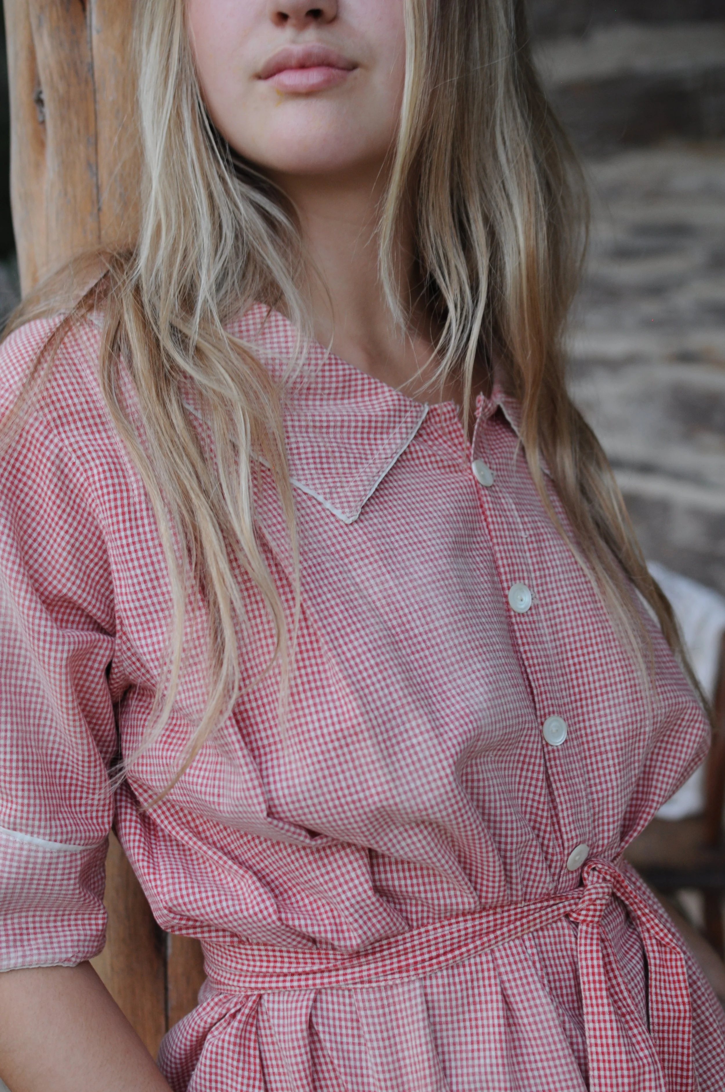 Detail of pointed collar and button-front bodice on vintage 1940s gingham house dress
