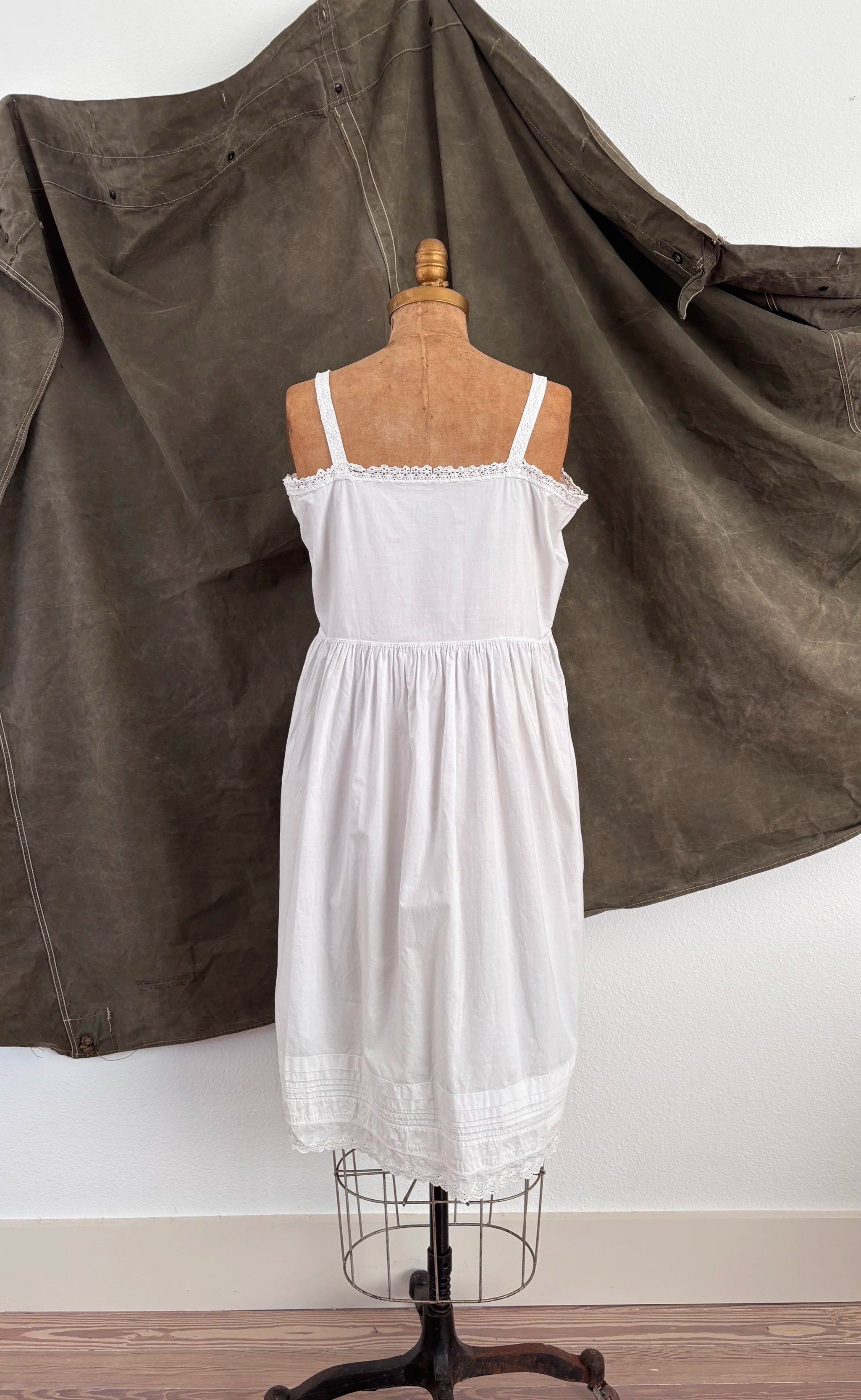 Back view of antique heirloom cotton empire waist slip dress on dress form