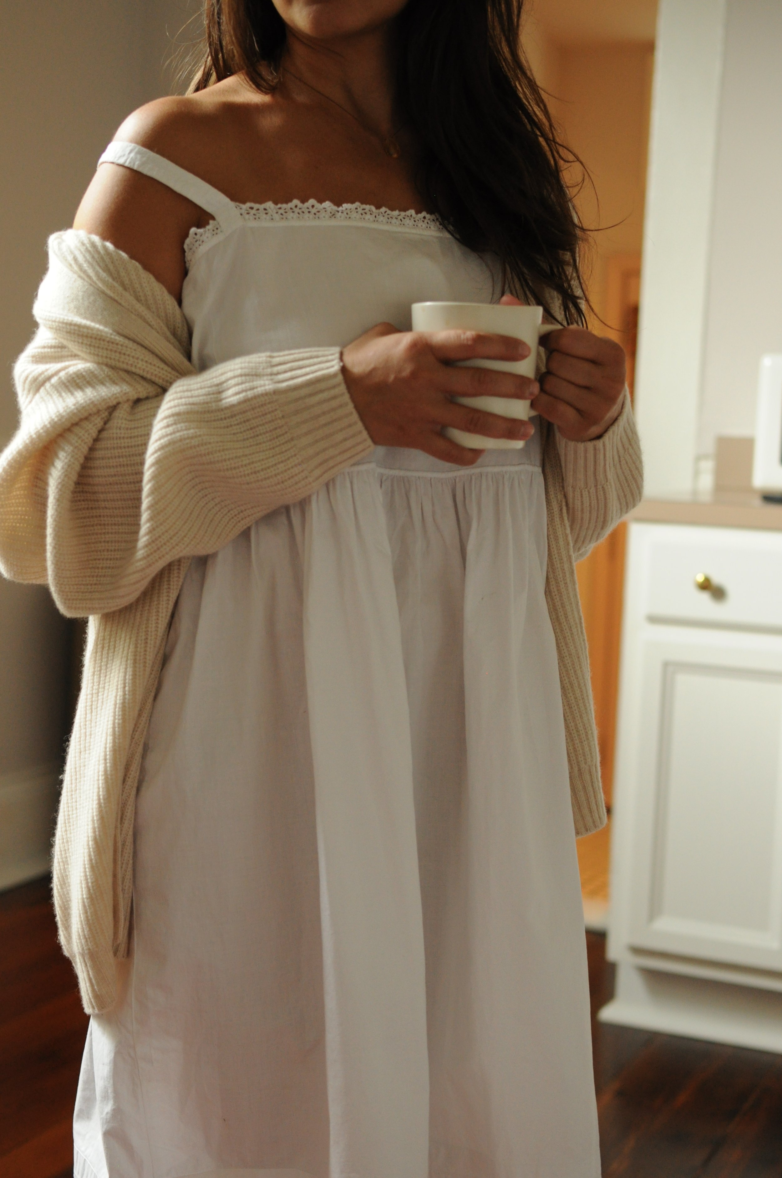 Close-up of empire waist and lace-trimmed neckline on antique cotton slip dress