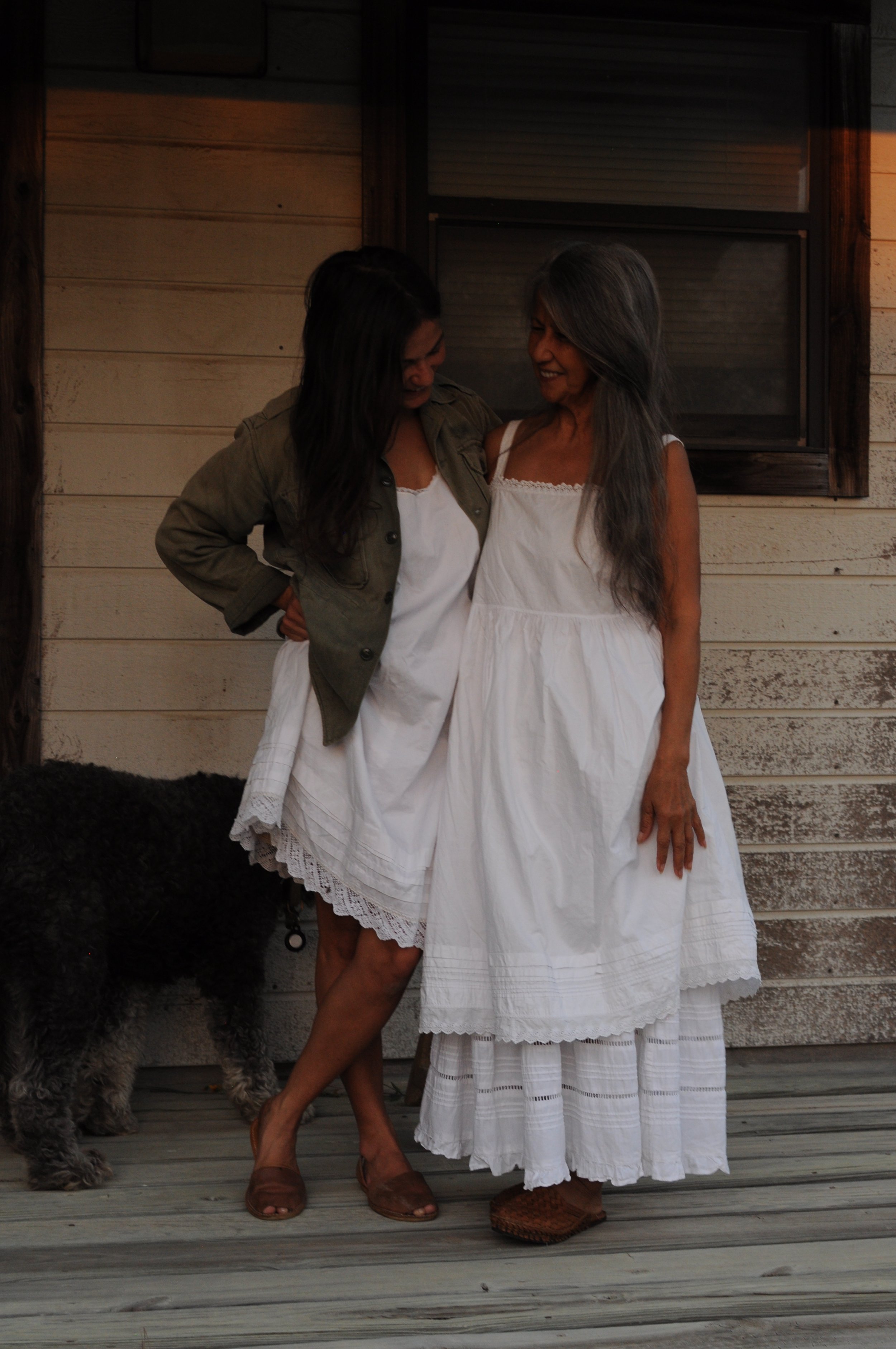 Woman wearing antique cotton empire waist slip dress layered with vintage skirt