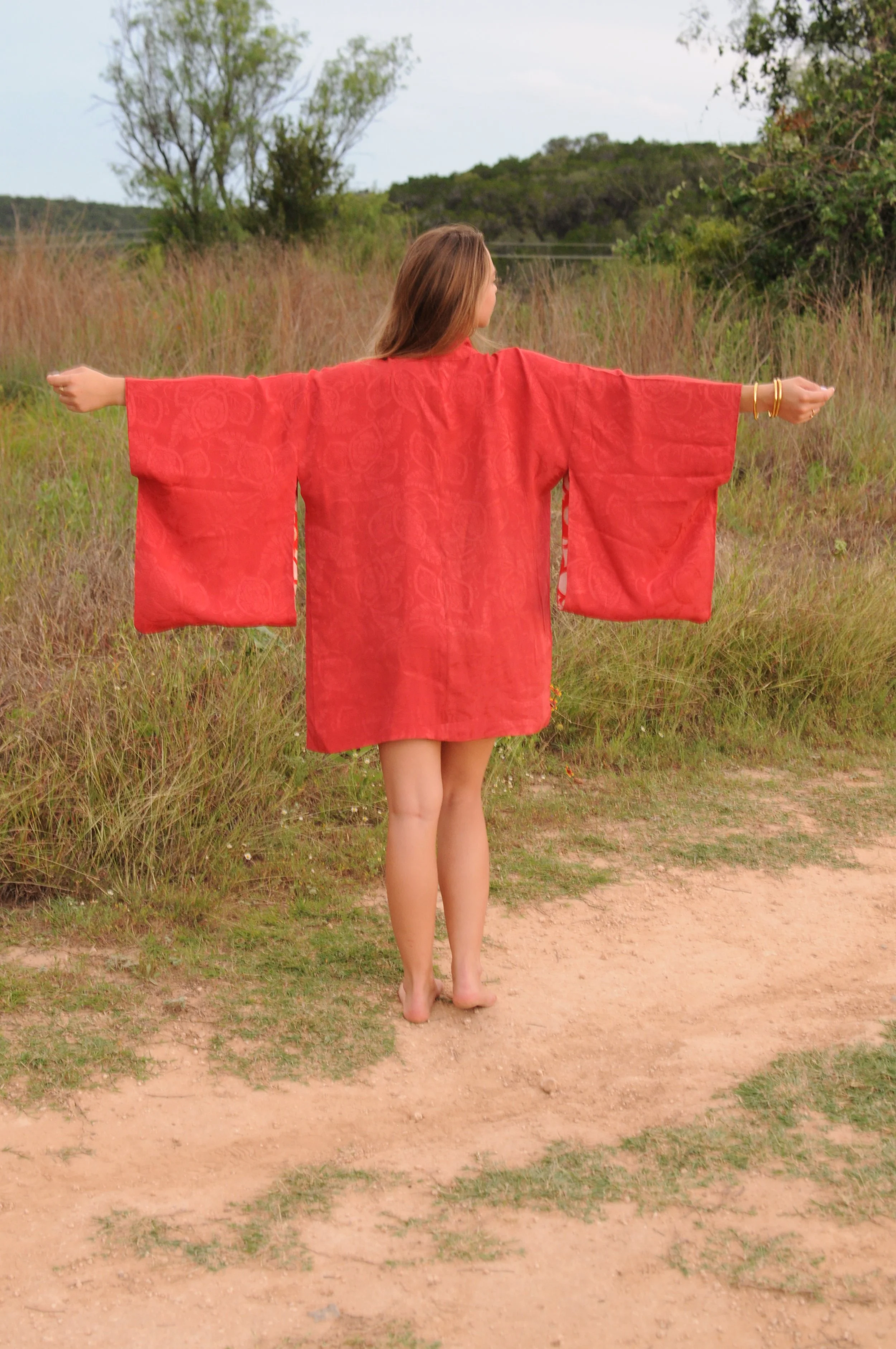 Back view of vintage crimson silk haori with traditional kimono silhouette