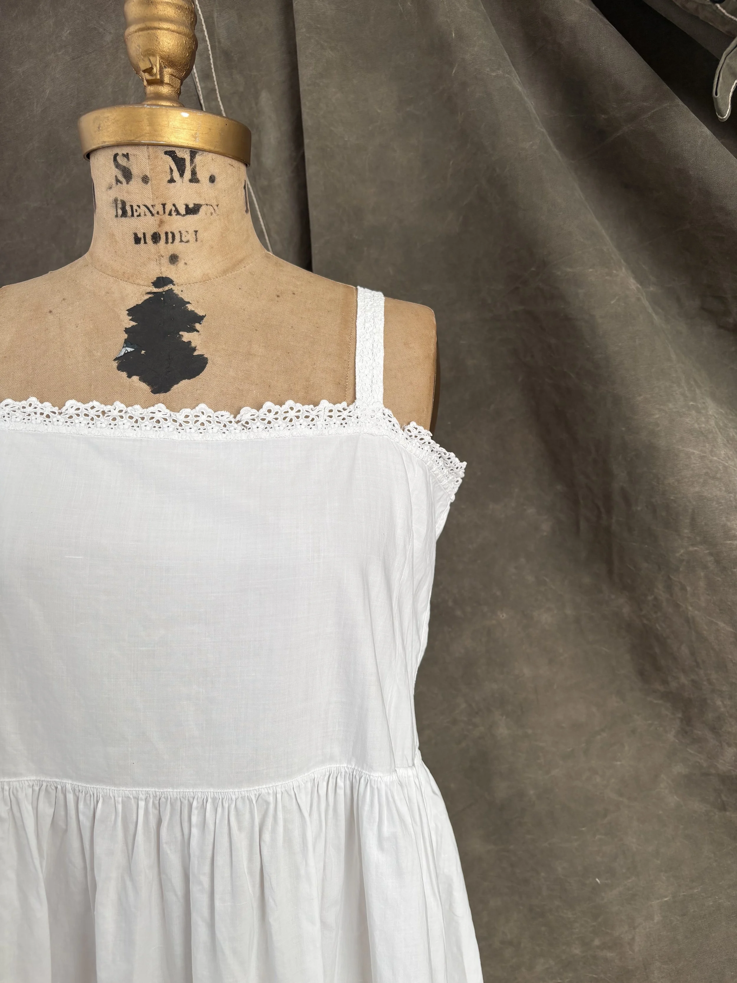 Close-up of empire waist bodice and lace-trimmed neckline on antique cotton slip dress