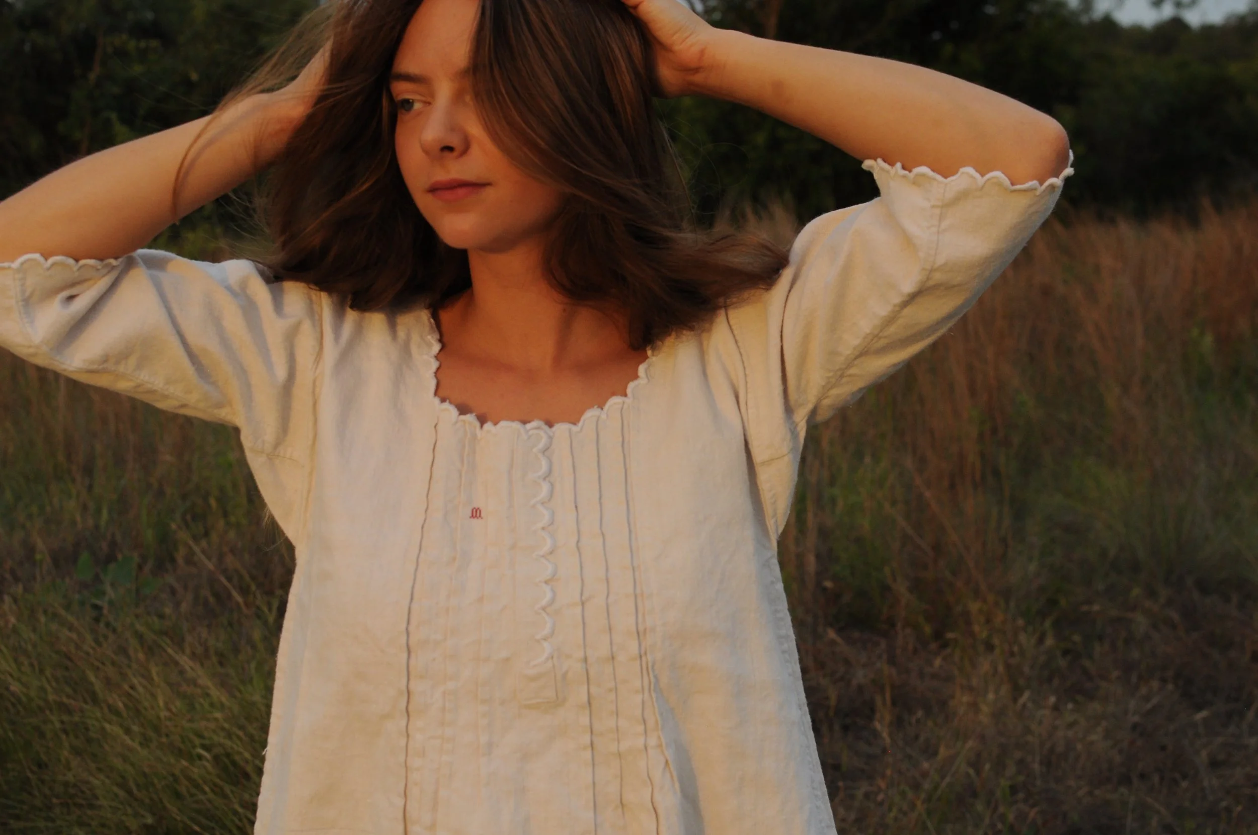 Portrait of antique French homespun linen dress showing square neckline and pintucks