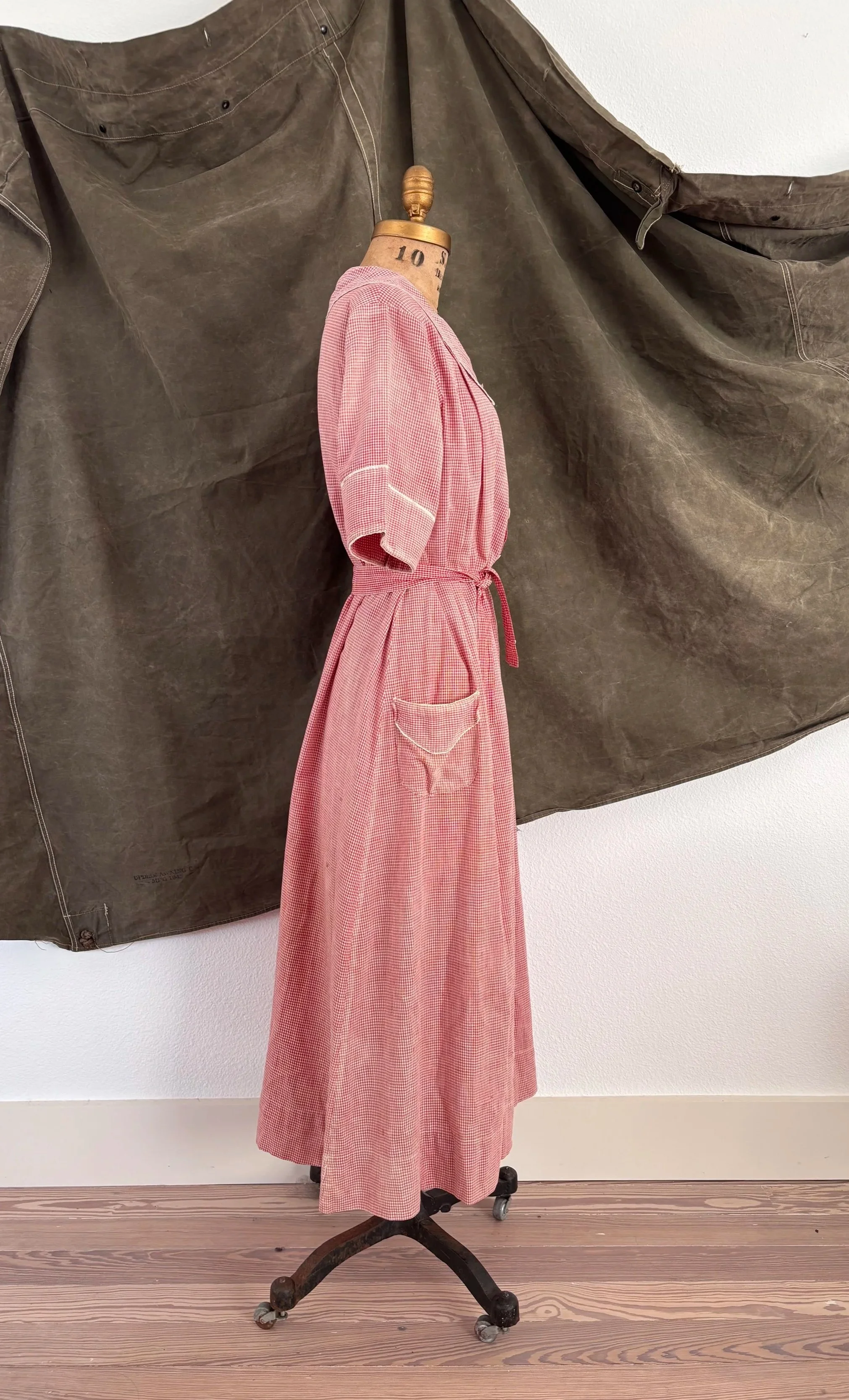 Side view of vintage 1940s strawberry gingham house dress on dress form