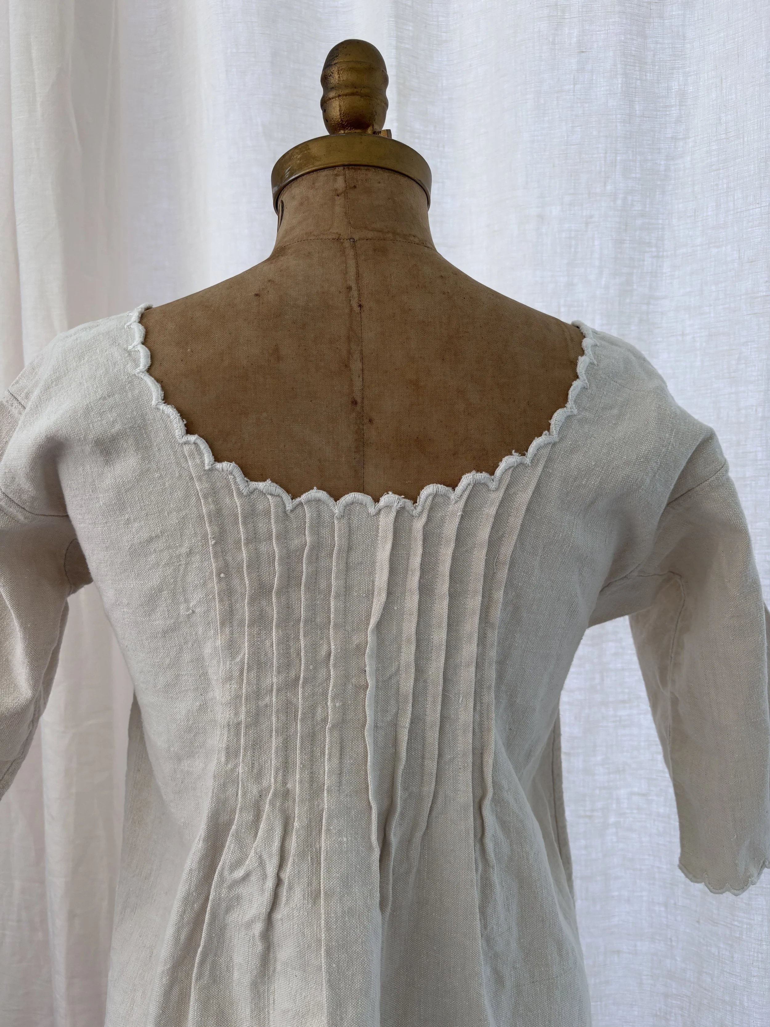 Close up of back view of antique Edwardian French homespun linen day dress on dress form