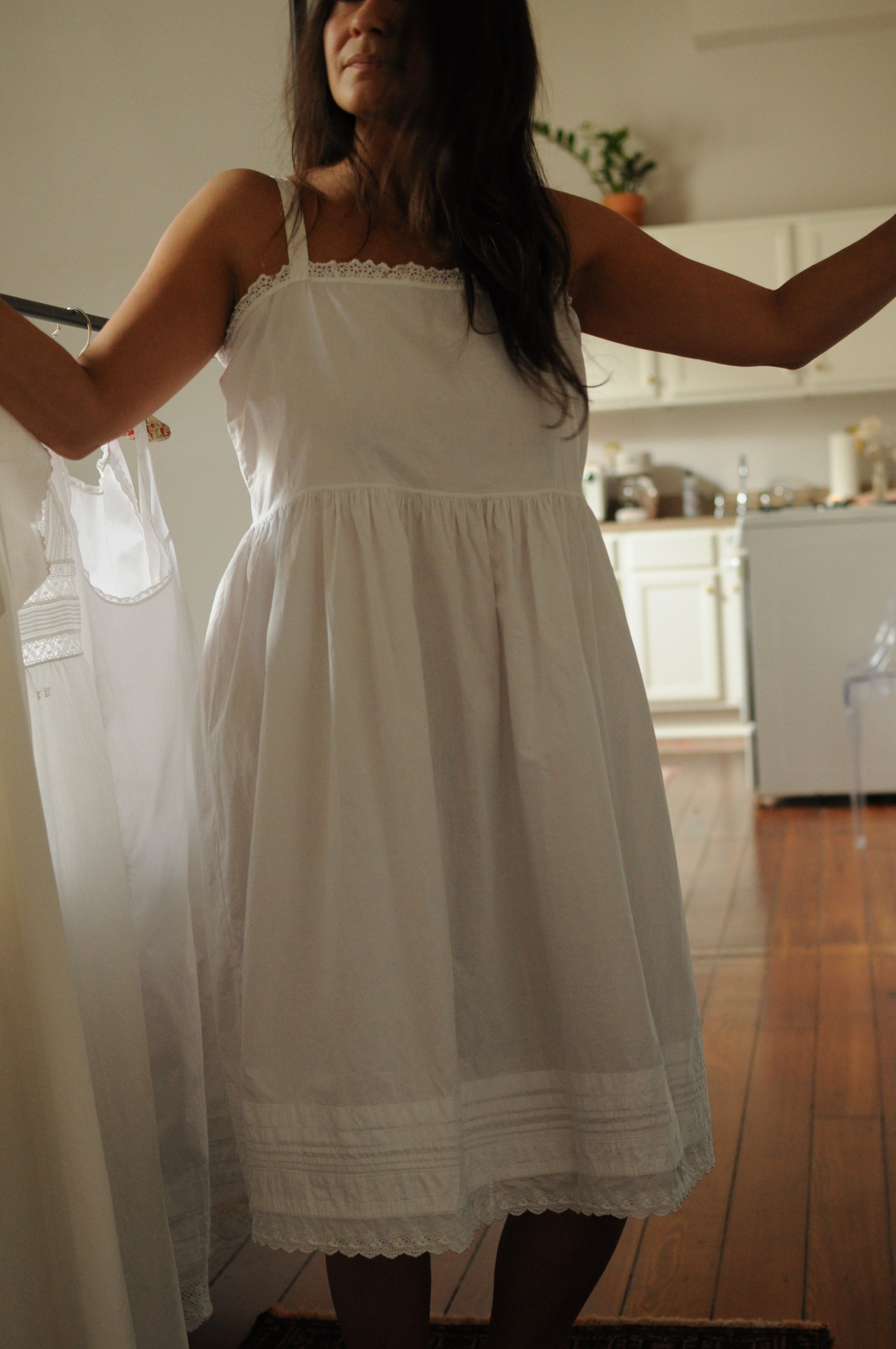 Front view of antique 1920s empire waist cotton slip dress showing gathered bodice