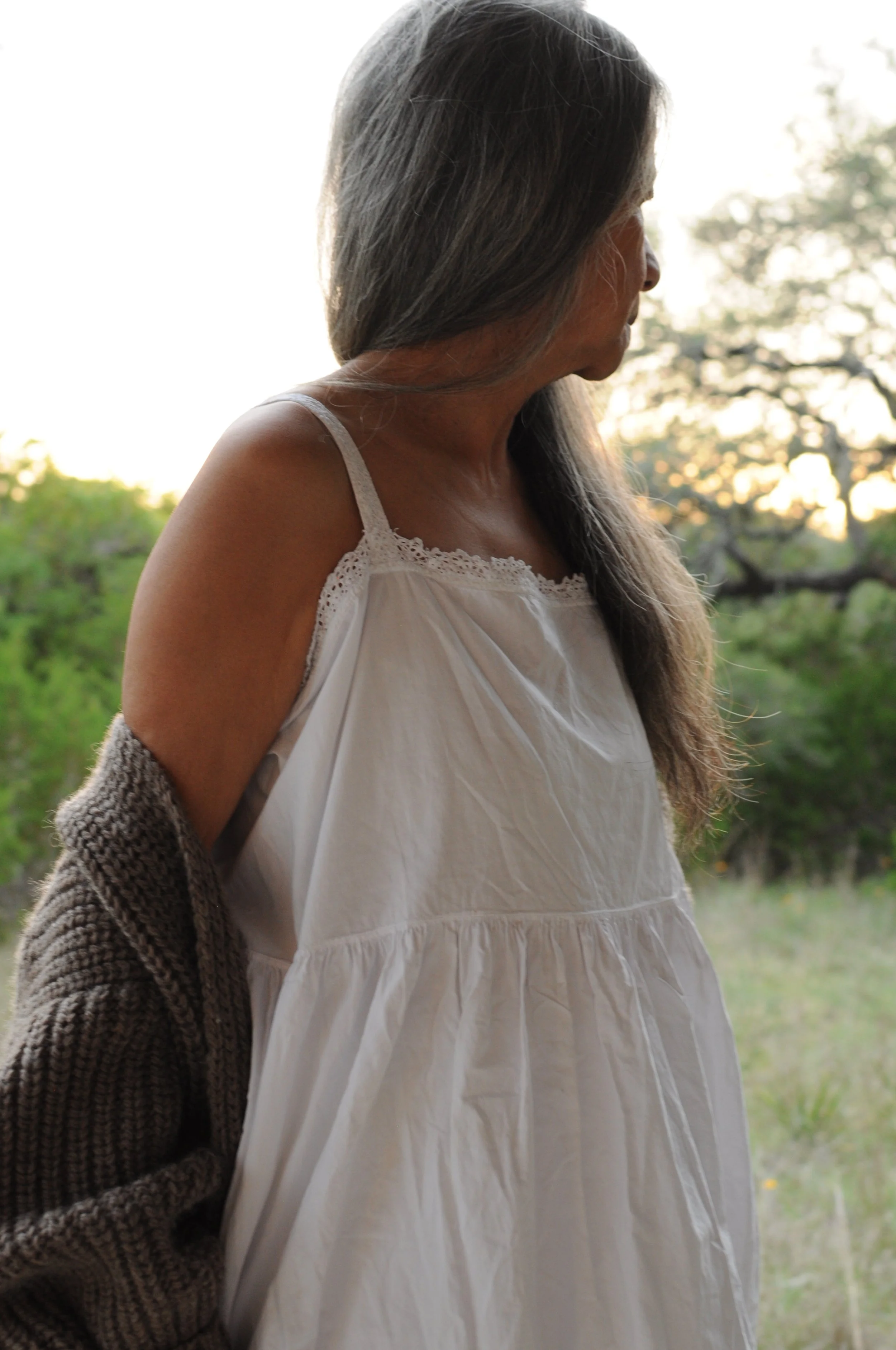 Close-up of lace-trimmed neckline and shoulder straps on antique cotton slip dress