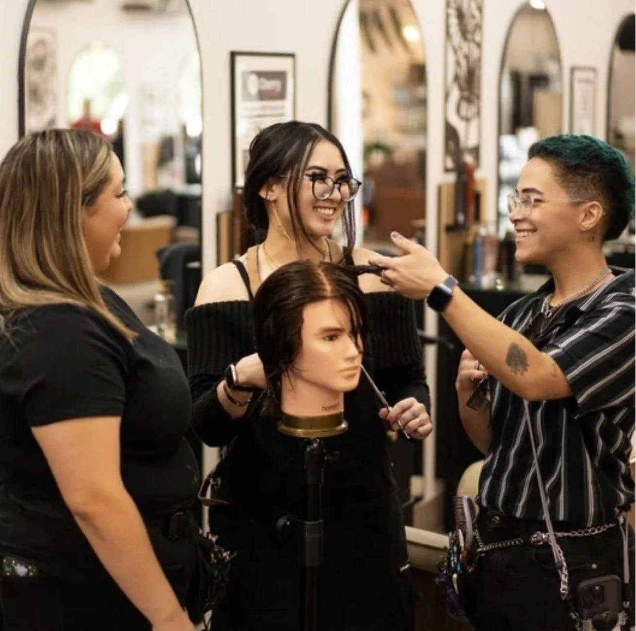 Students training with a working stylist at FOUSHEE