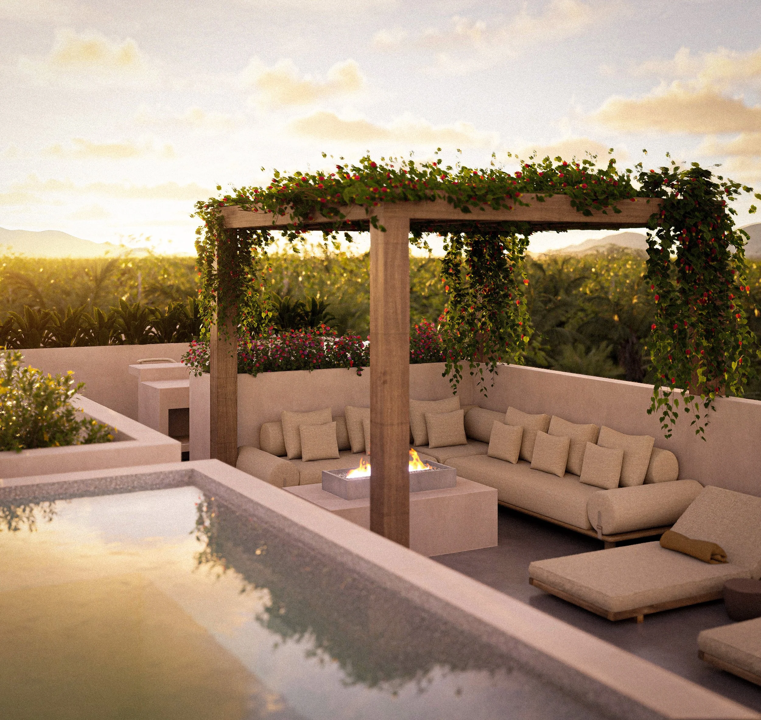 Área de descanso en azotea con muebles beige, fuego en una chimenea y plantas con flores colgantes y en macetas, con vista a un campo y montañas al atardecer.