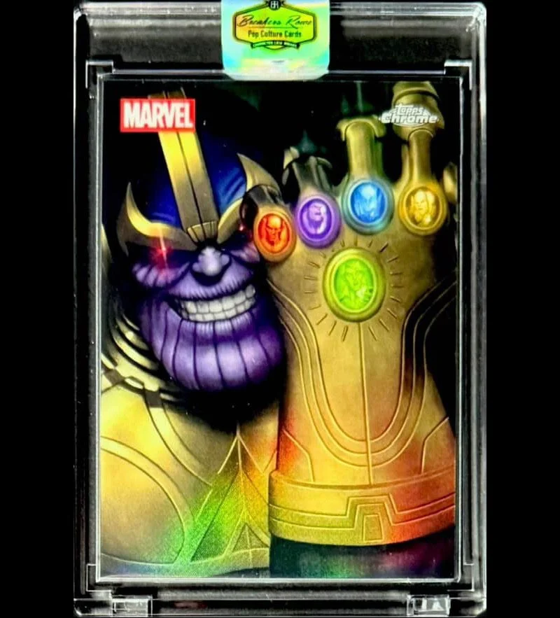 Marvel Thanos themed pop culture card with Thanos' purple face and hand, five Infinity Stones in different colors on the hand, and a Marvel logo.
