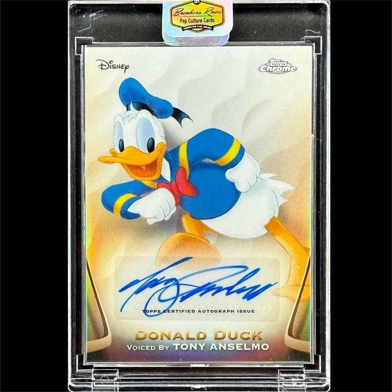 A Donald Duck themed Topps Chrome collectible card featuring Donald Duck in a sailor outfit, with an autograph and Tony Anselmo's voice credit, encased in a protective plastic case with a Pop Culture Cards sticker.