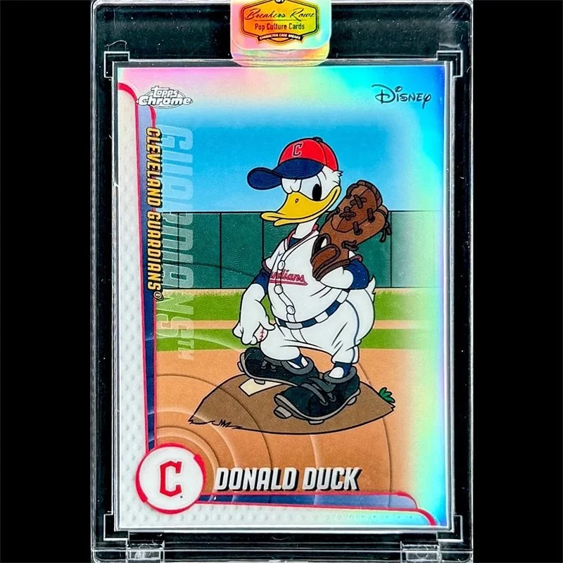 Collectible Disney baseball card featuring Donald Duck as a baseball player, standing on a baseball field with a glove on his left hand and wearing a red cap and jersey with a baseball bat in the background. The card is labeled 'Cleveland Guardians'