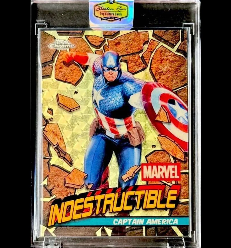 Marvel Captain America trading card with superhero in blue suit with stars and stripes, breaking through a brick wall background, titled 'Indestructible'.