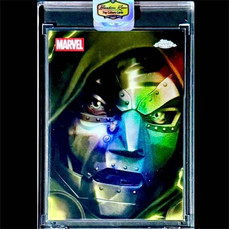 A collectible Marvel comic card featuring a detailed depiction of a faceless, metallic robotic figure with glowing green eyes, wearing a dark green hood, encased in a protective plastic display case with a Topps Chrome logo at the top and a small car