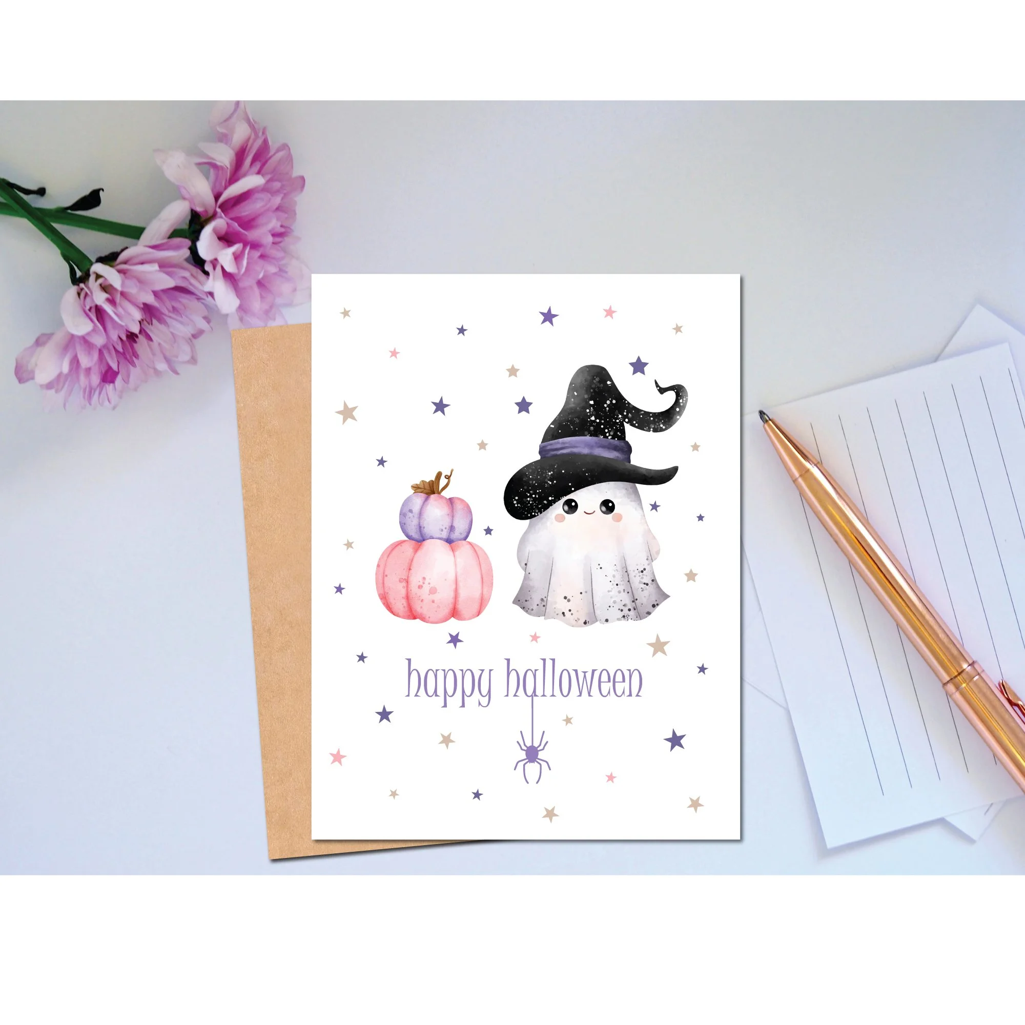 Featuring a sweet little ghost wearing a witch’s hat, a stack of pastel pumpkins, and scattered stars, this card brings a touch of spooky charm with a cute and whimsical style.