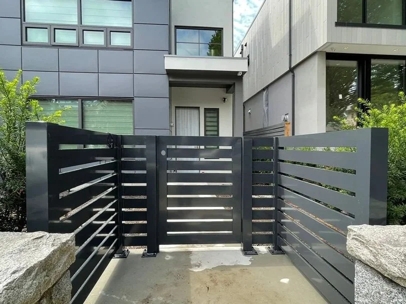 Custom black metal driveway gate for modern apartment in Vancouver by Iron Age Manufacturing