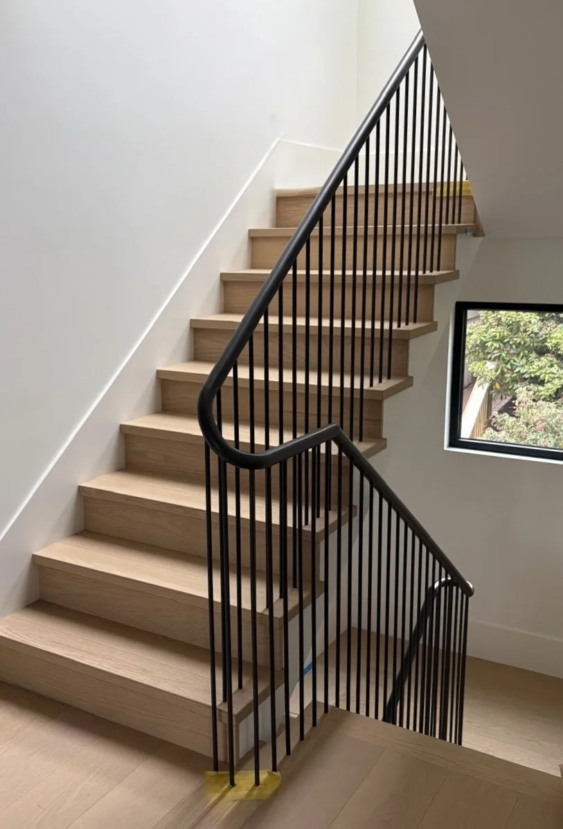 Completed custom interior railing connecting multiple stair flights