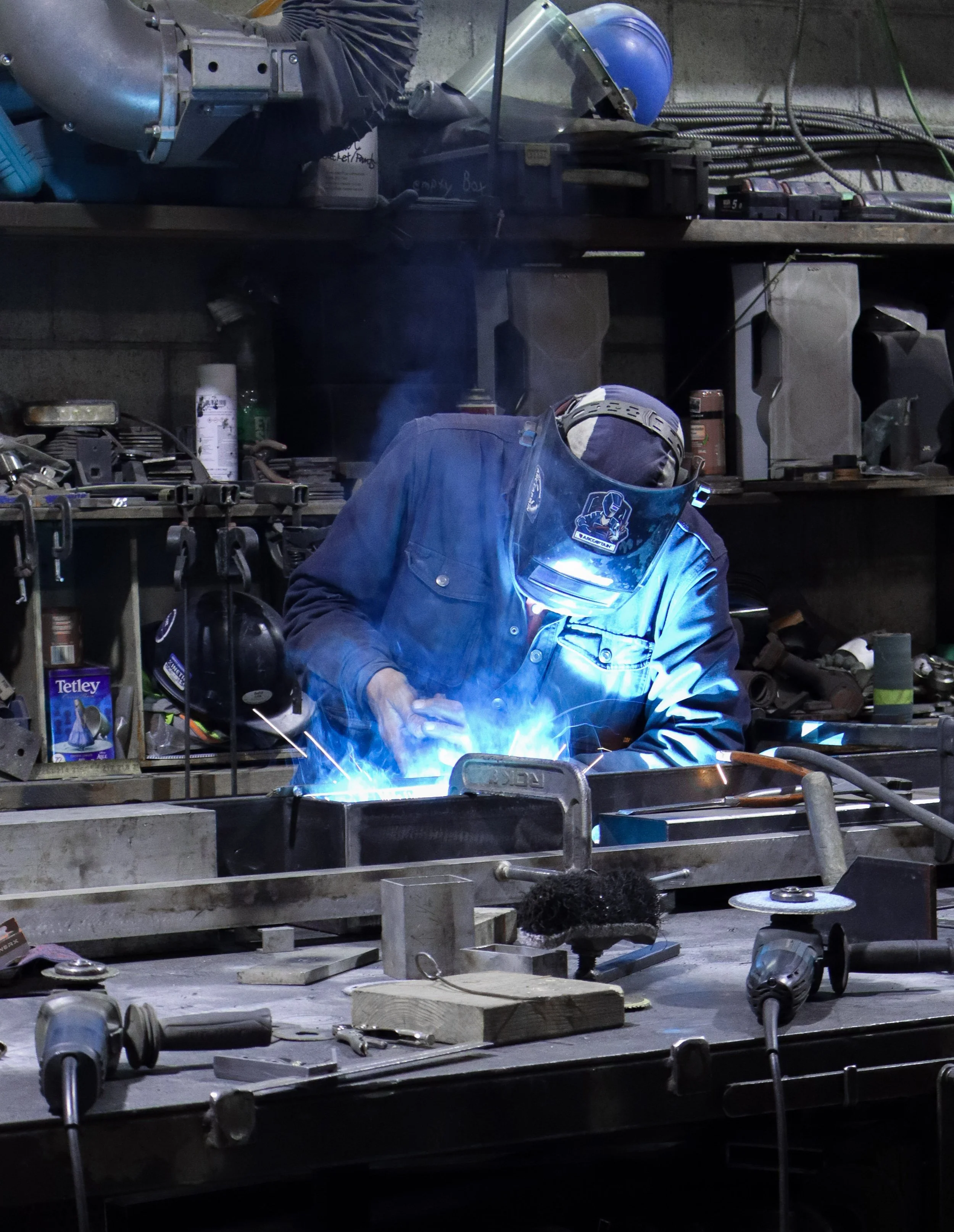 Welder fabricating custom steel components at Iron Age’s Vancouver workshop