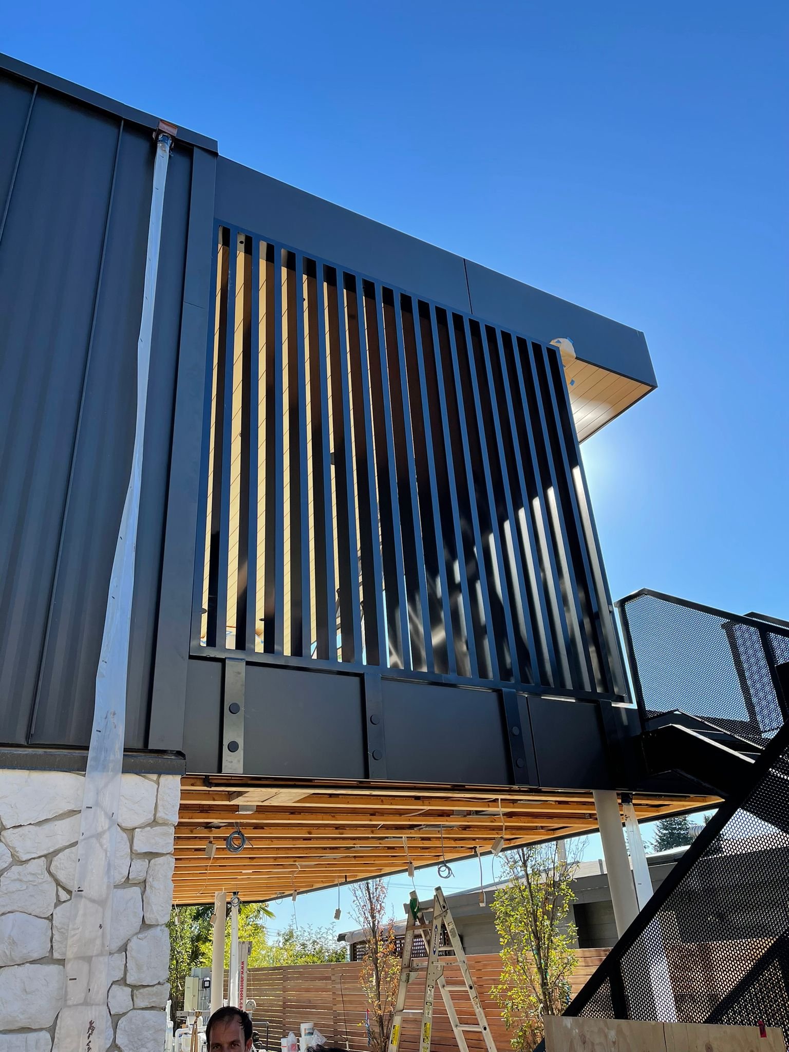 Custom architectural metal façade with vertical steel slats and exterior detailing