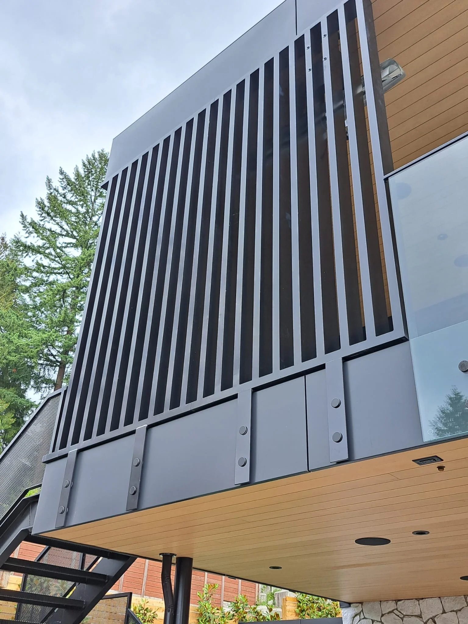 Custom vertical metal privacy screen Vancouver modern residential exterior