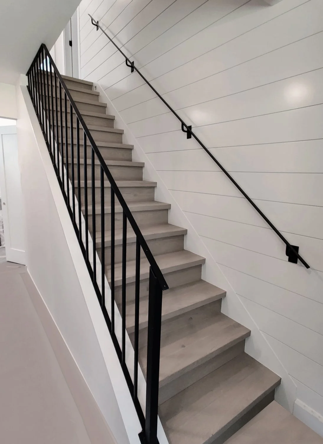 Contemporary black railing system for interior stairs Vancouver BC