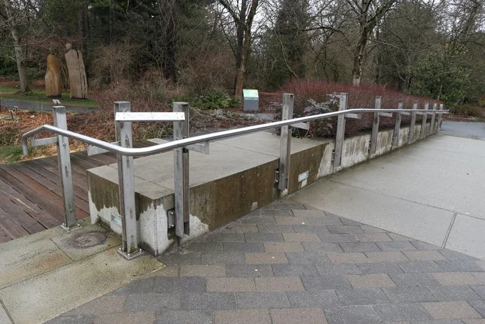 Accessible stainless steel handrail and guardrail for a public walkway at VanDusen Botanical Garden.