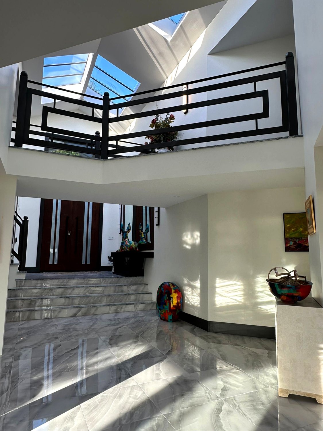 Grand staircase with custom fabricated metal guardrail Vancouver