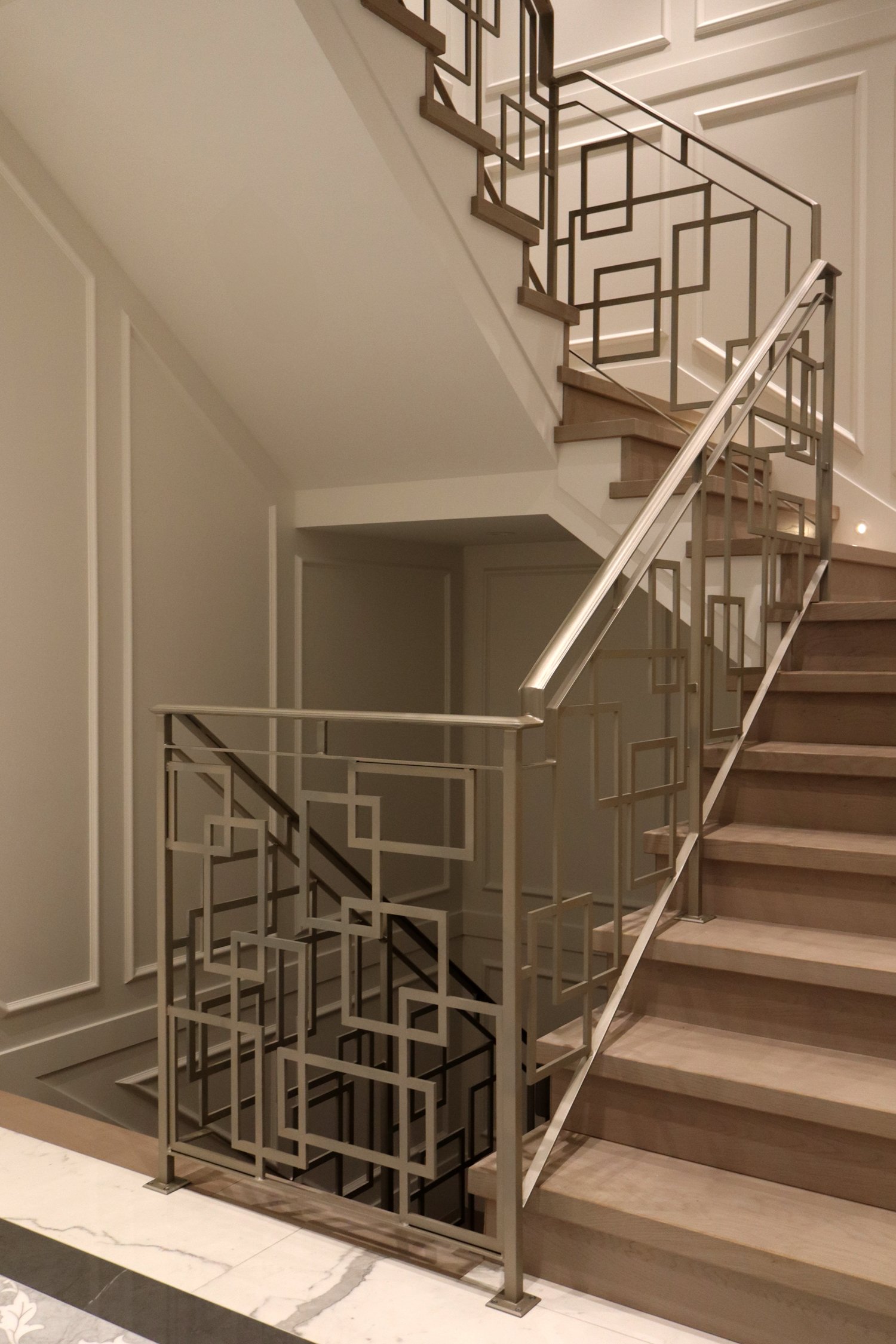 Custom geometric metal staircase railing for modern Vancouver interior
