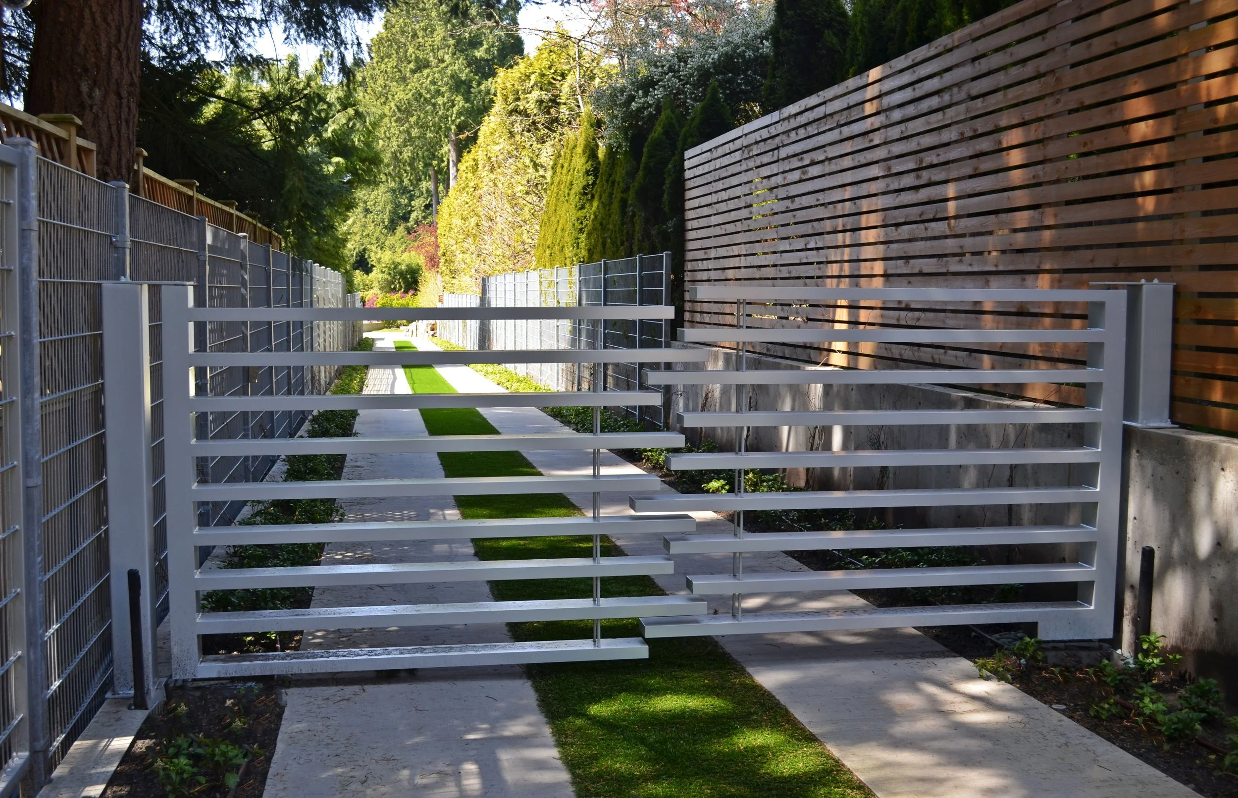 Contemporary metal and wood privacy fence for residential backyard design