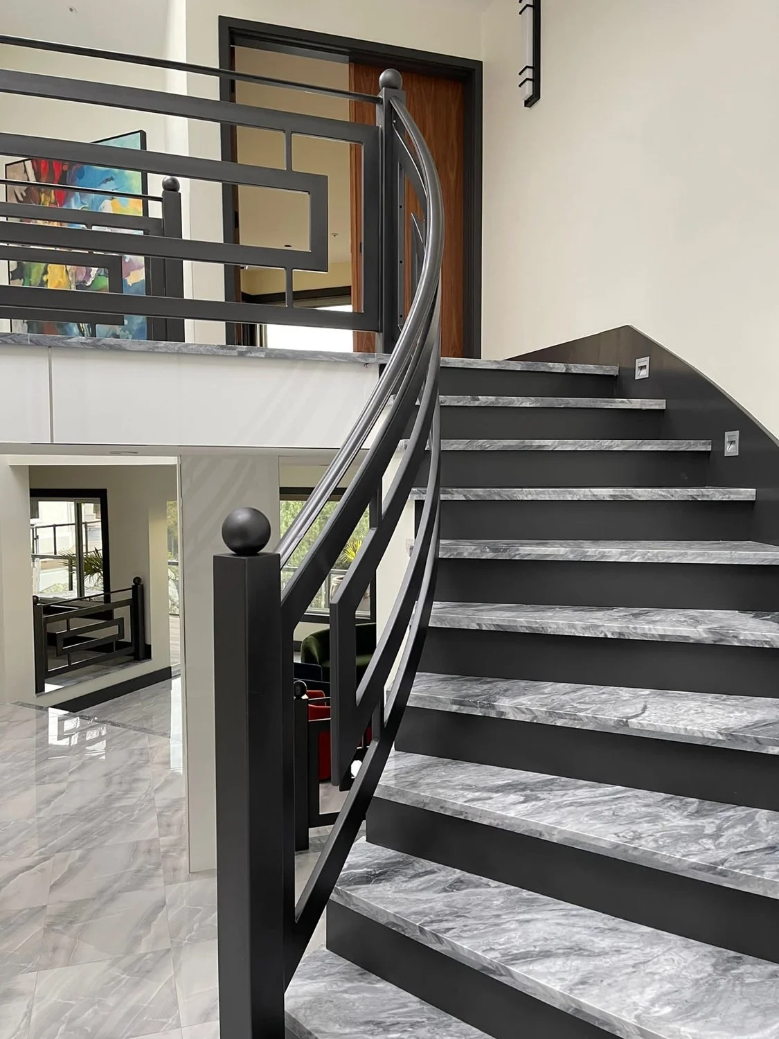 Curved interior stair railing with elegant metalwork Vancouver