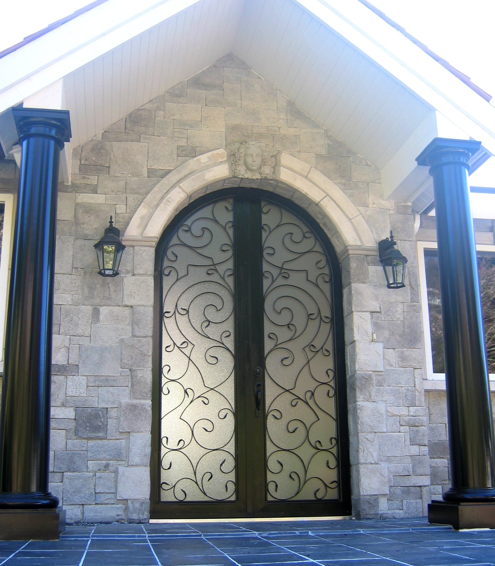 custom arched metal door vancouver residential entrance