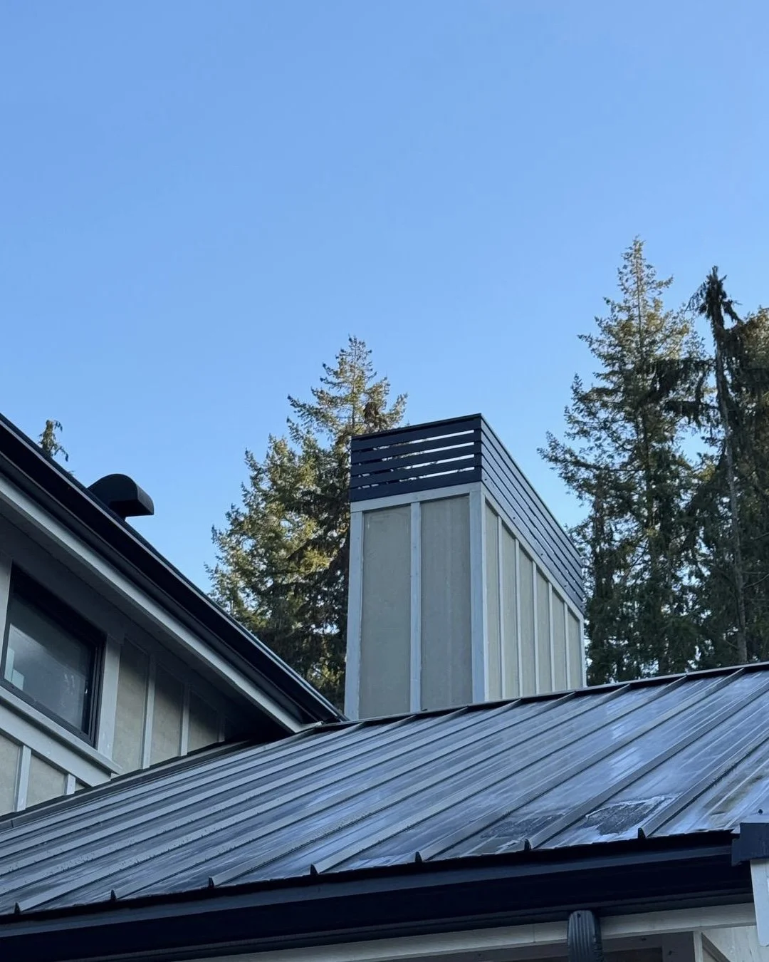 Metal chimney cap on sloped roof Vancouver residential