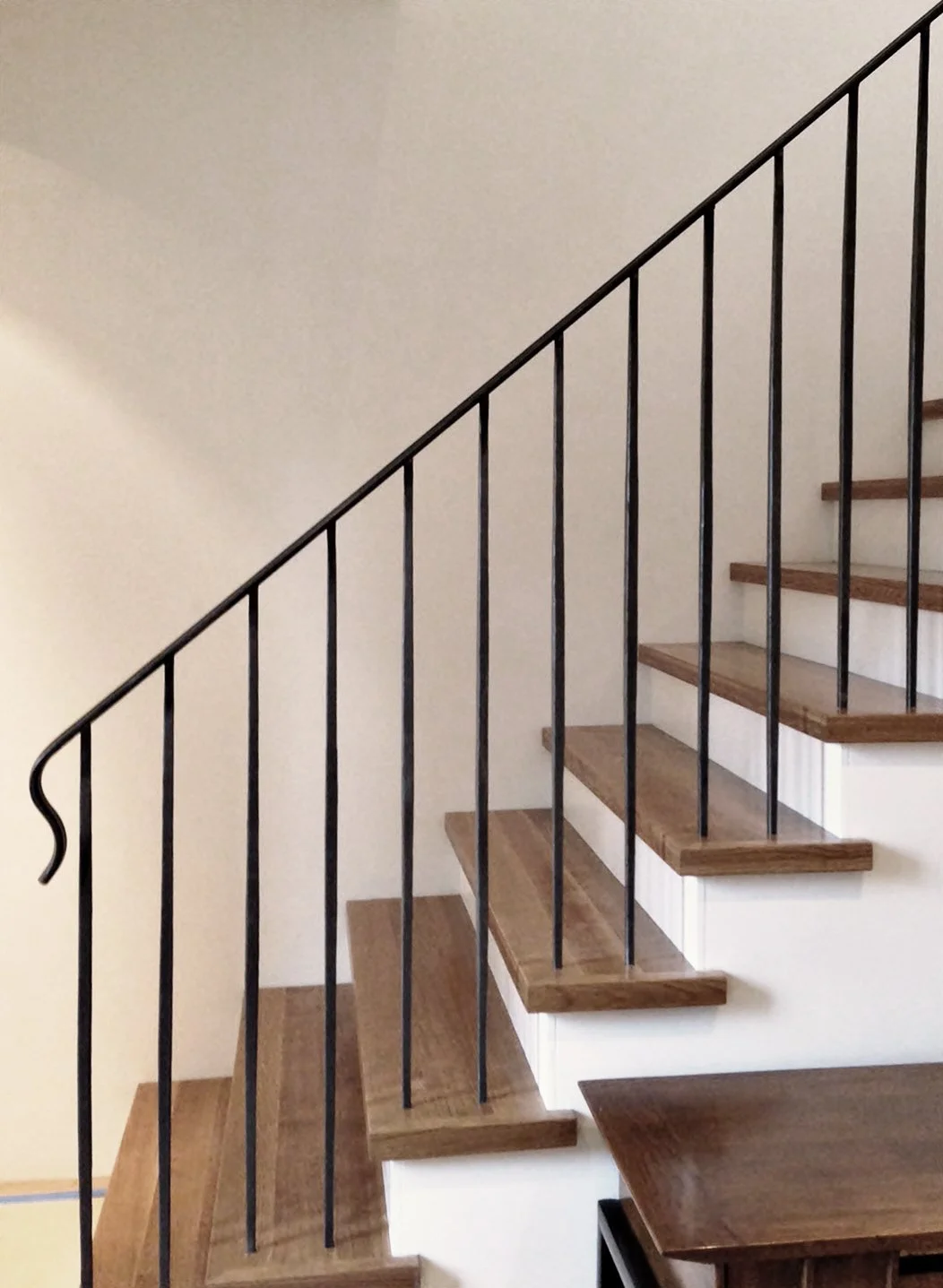 Modern interior staircase with custom black metal railing in Vancouver residence