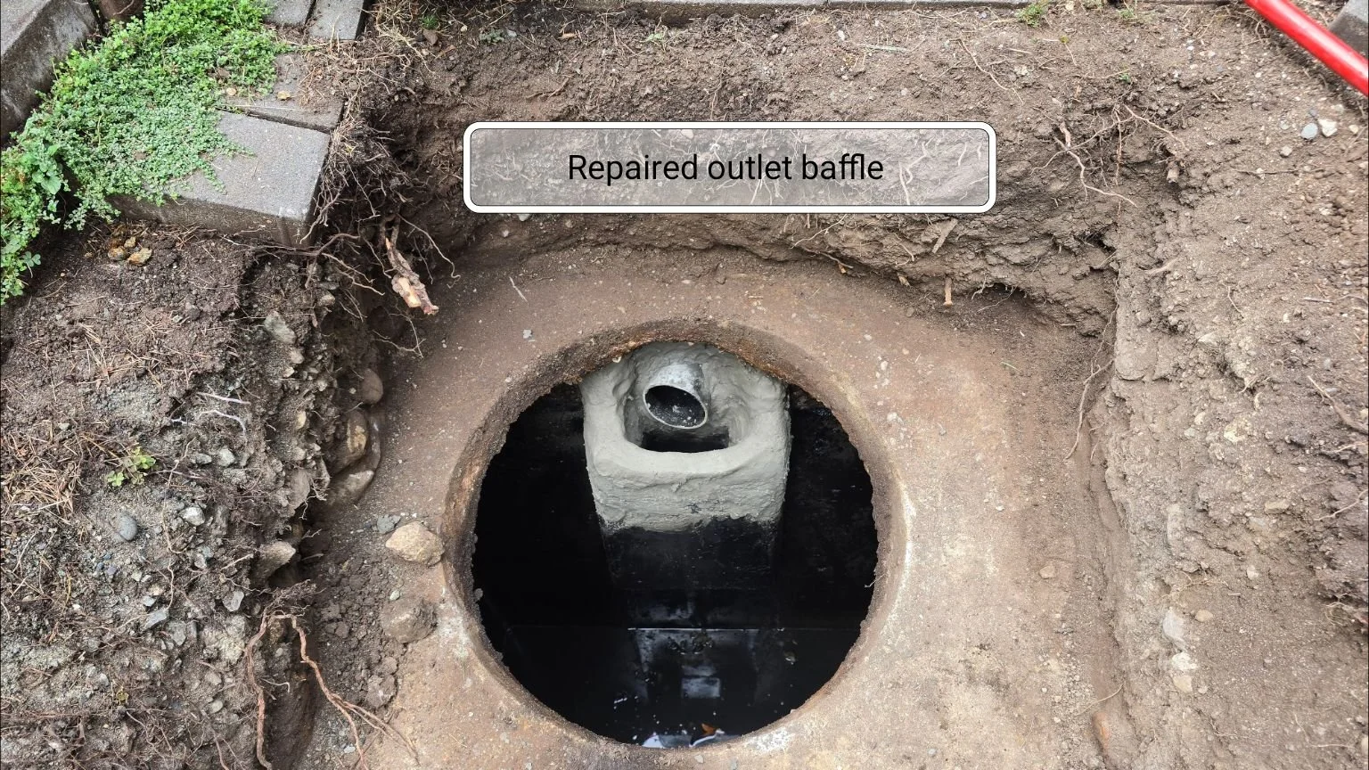 A repaired concrete septic tank baffle