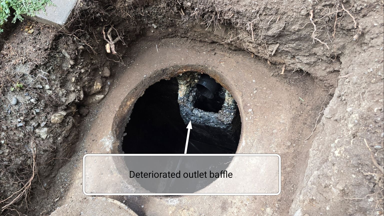 A deteriorated concrete septic tank baffle