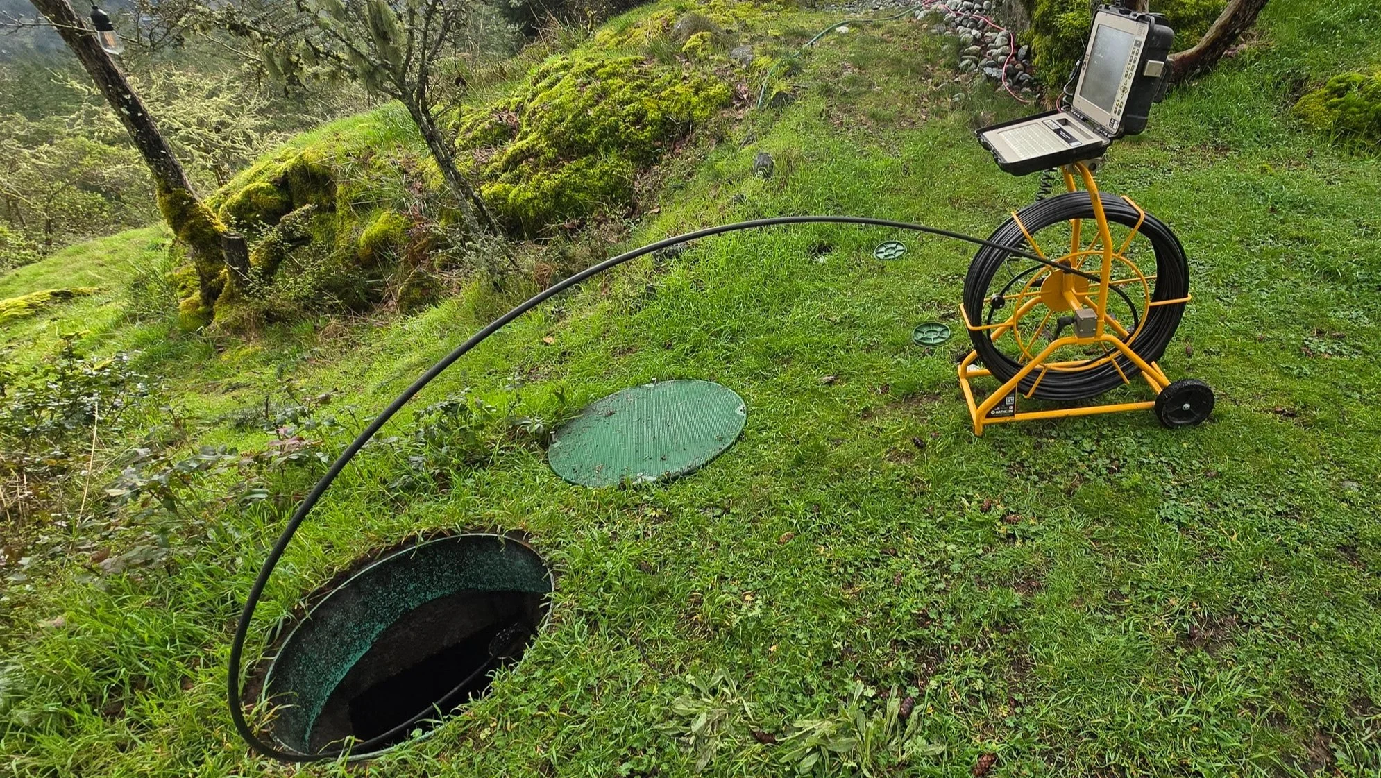 A pipe inspection camera in use during a septic system inspection