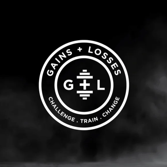 white circle with "Gains + Losses" arched over the top and "Challenge. Train. Change." arched at the bottom. In the center is a G + L with the "+" making a dumbbell