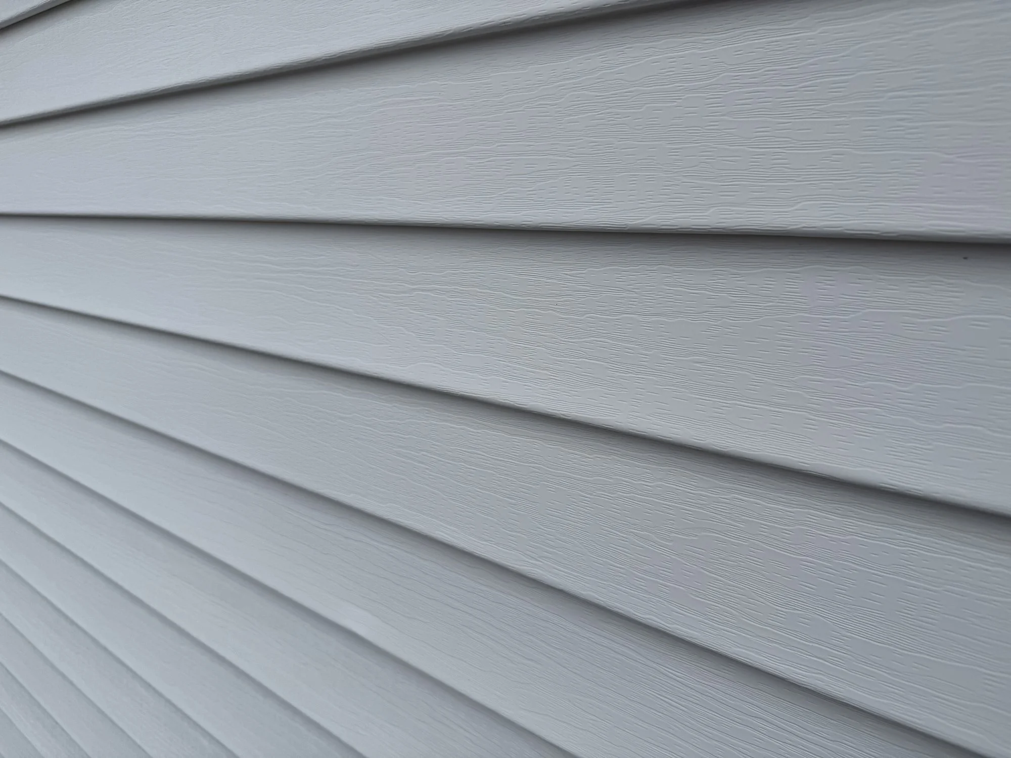 Gray vinyl siding on house. 