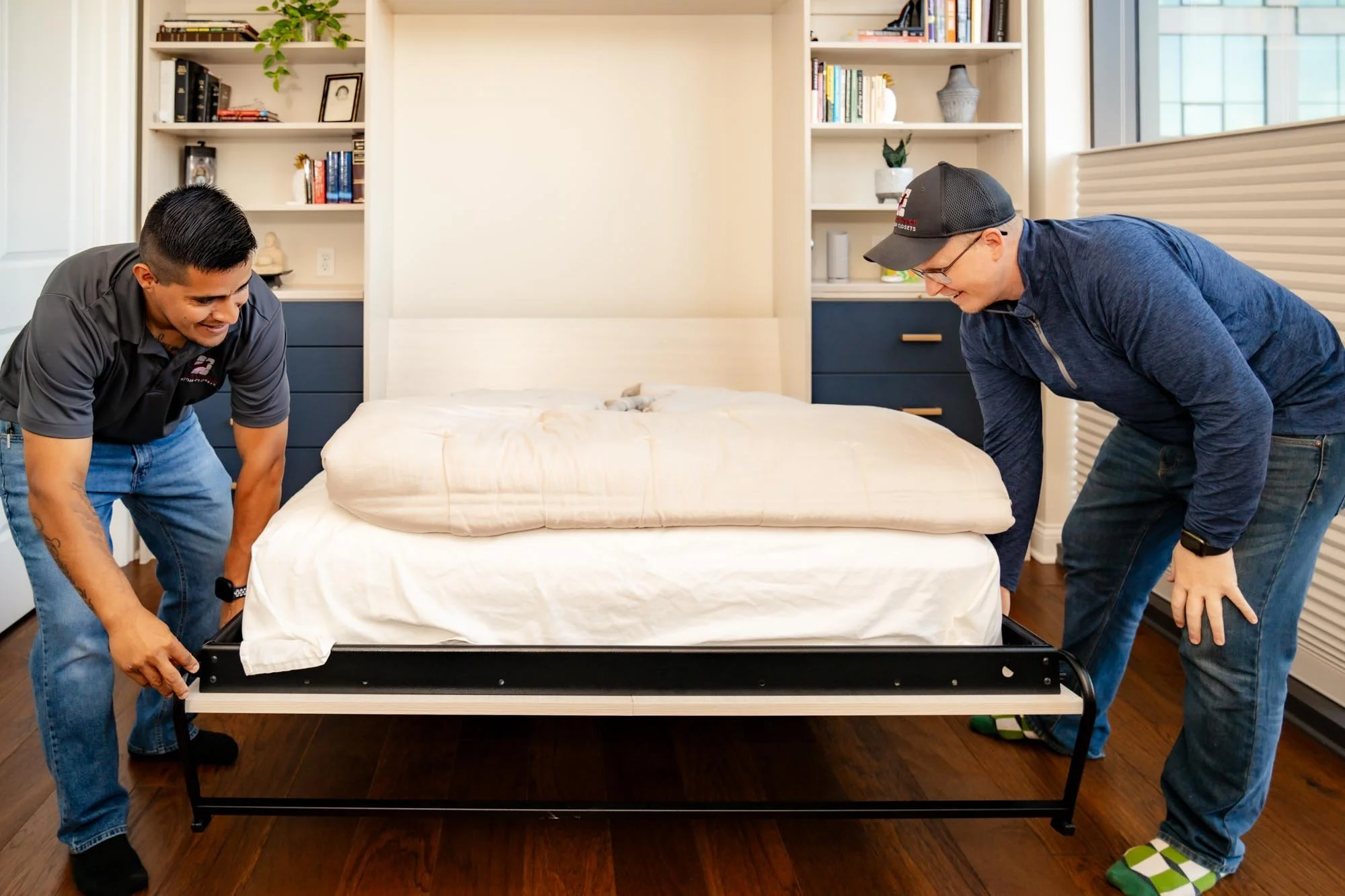 Elevate Outfitters crew assembles a custom made Murphy bed frame with custom display shelving in Columbus, Ohio.