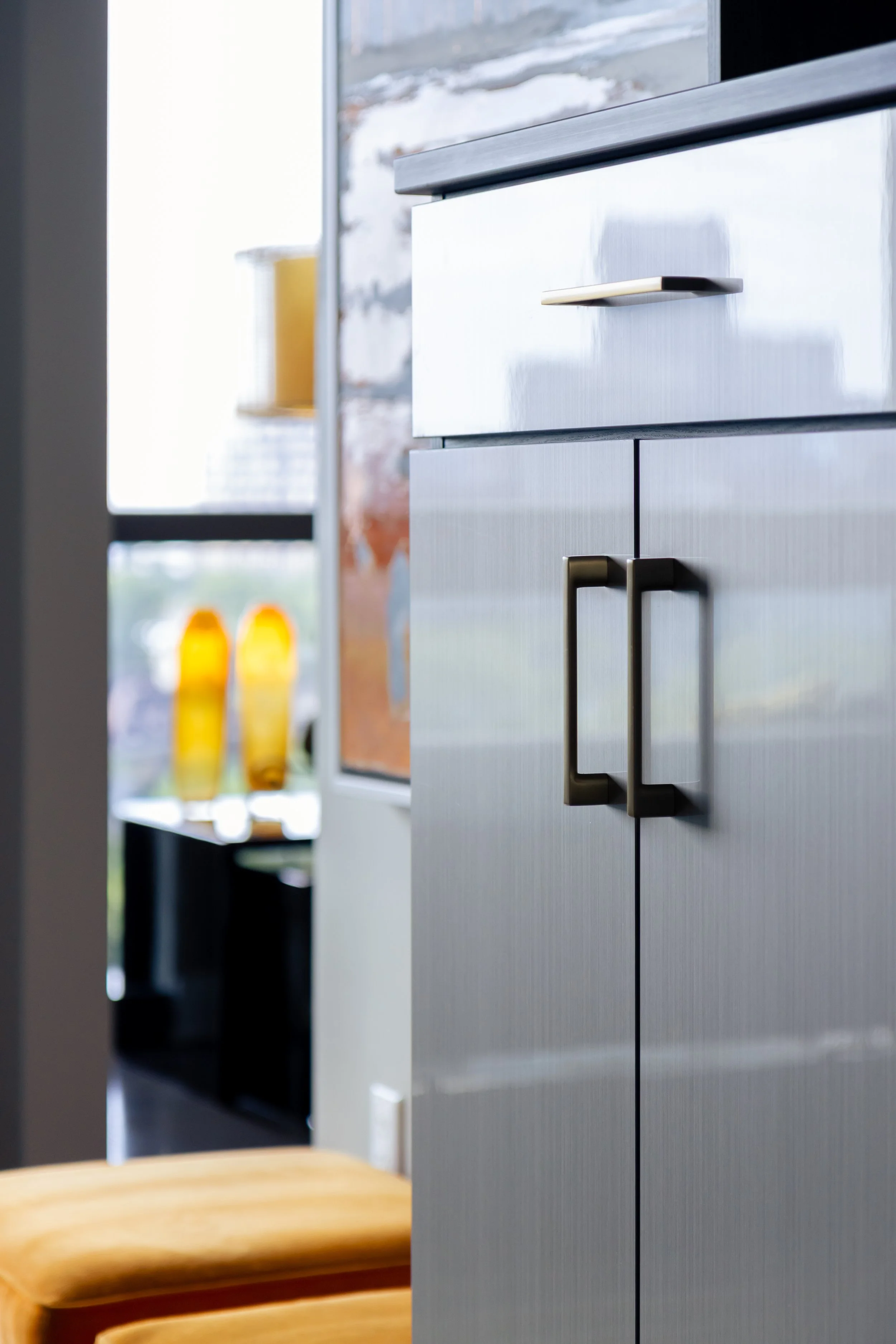 Close-up of modern commercial cabinets with metallic handles.