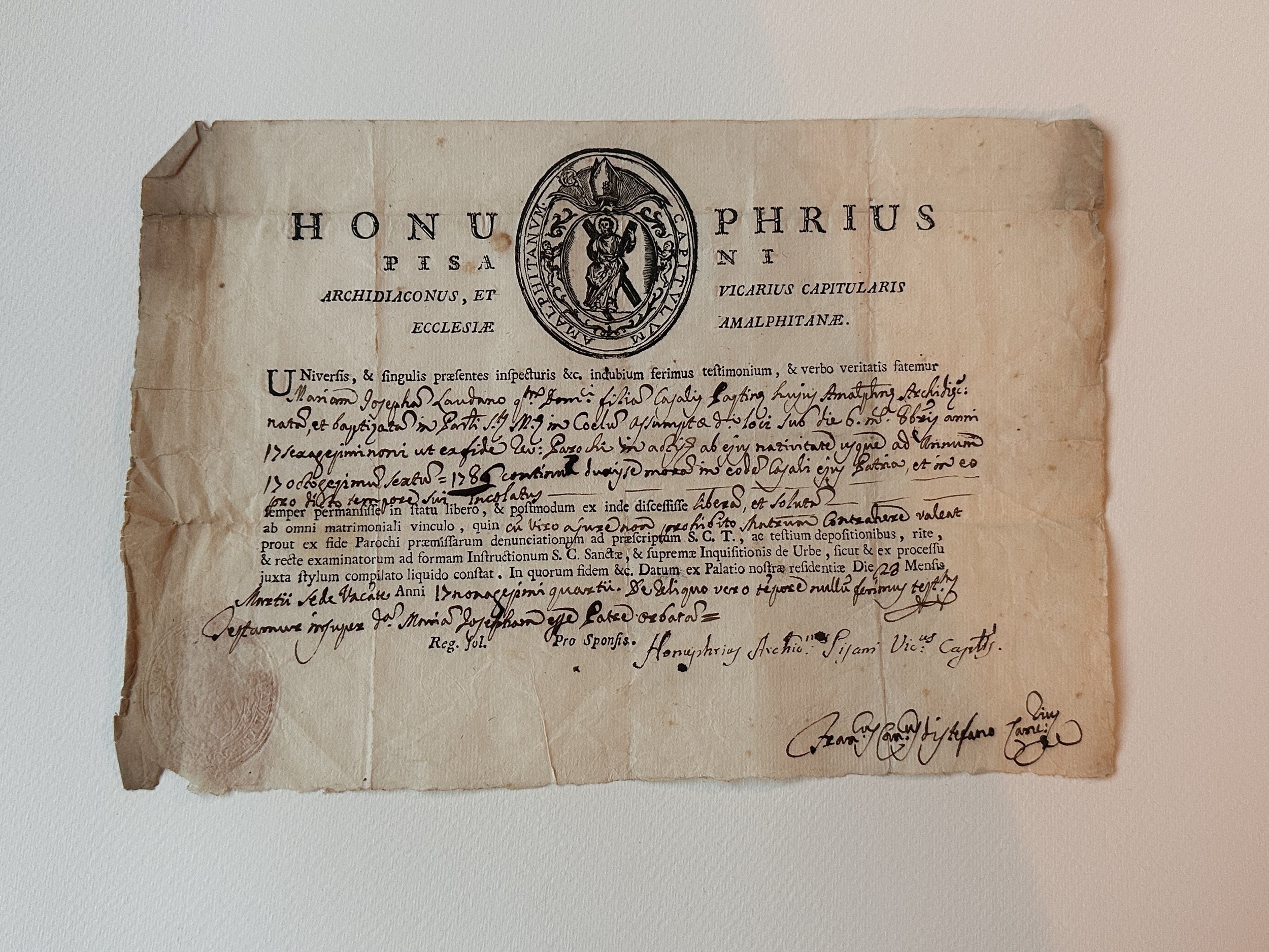 Historic Italian manuscript on aged paper with Latin text, stamped seal, and archival markings.