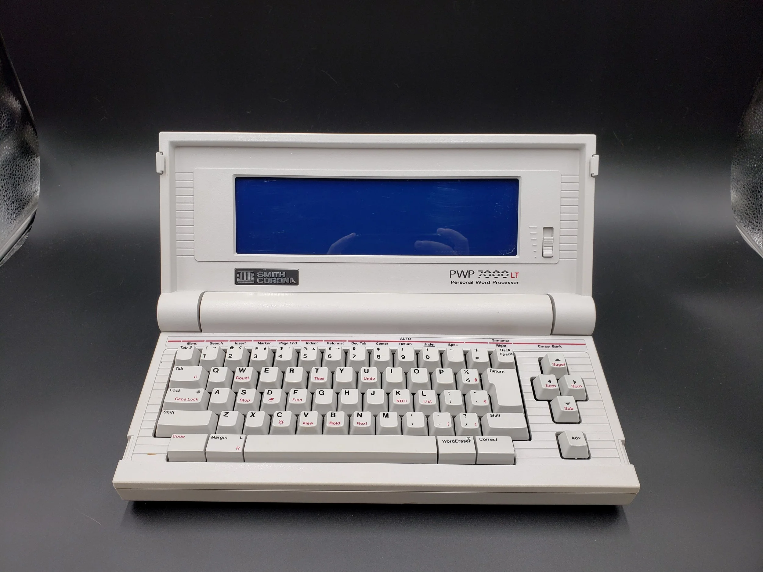 A vintage Smith Corona portable personal word processor with a built-in screen and keyboard.