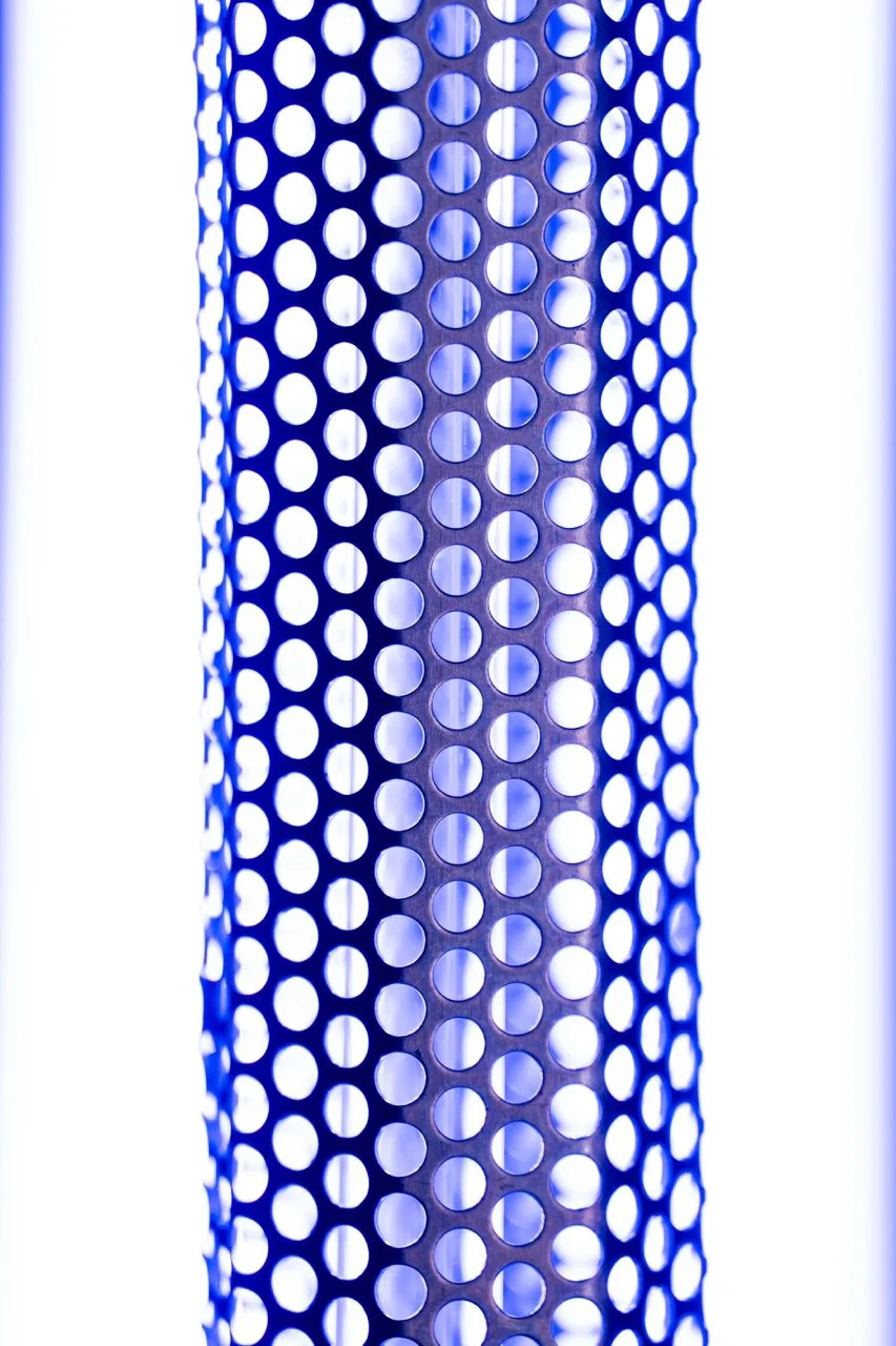 a metal honeycomb shaped grated cylinder uv light reflecting purple ultraviolet light by Econo air
