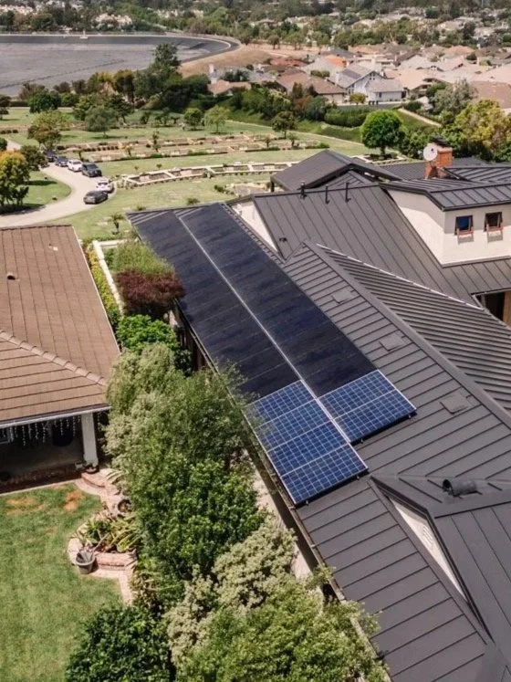solar panels on the roof of a large home in Southern California on a sunny day