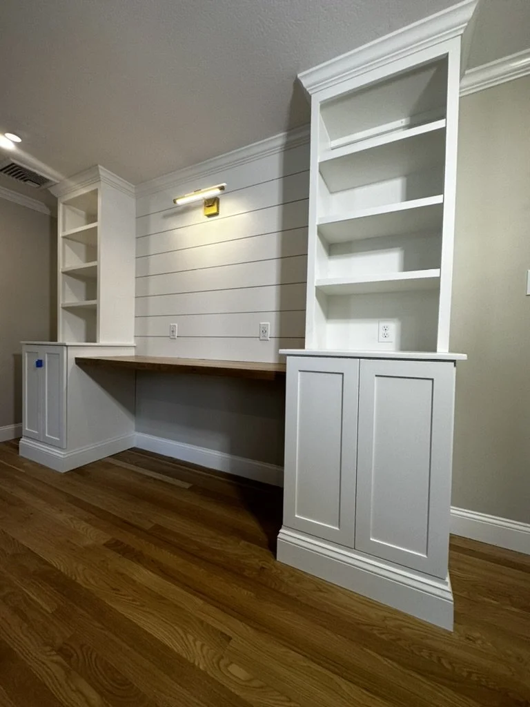 A floating fine finish desk surrounded by storage.