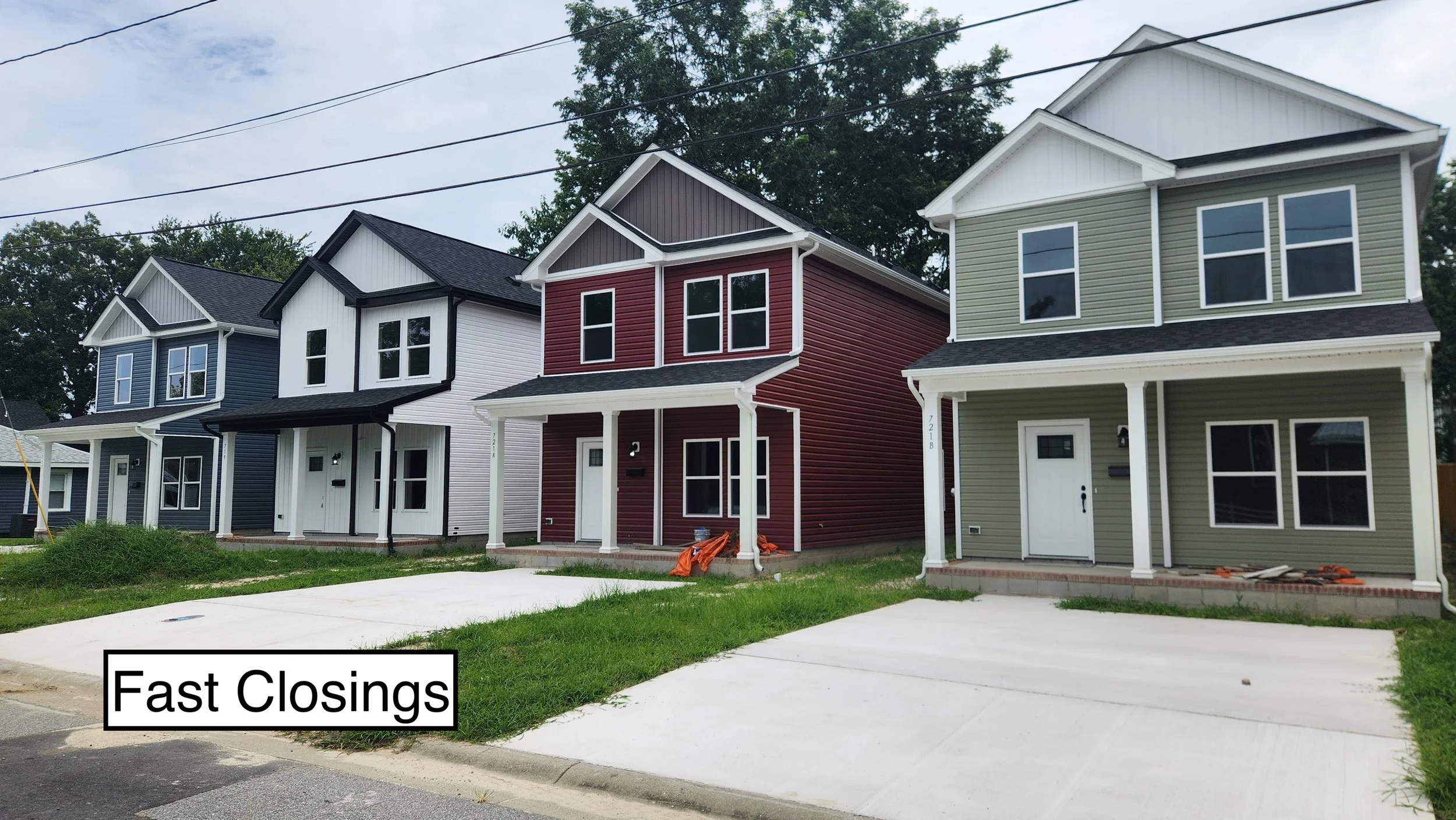 Row of newly constructed colorful single-family homes with front porches and driveways, under construction, with a caption reading "Fast Closings" in the foreground.