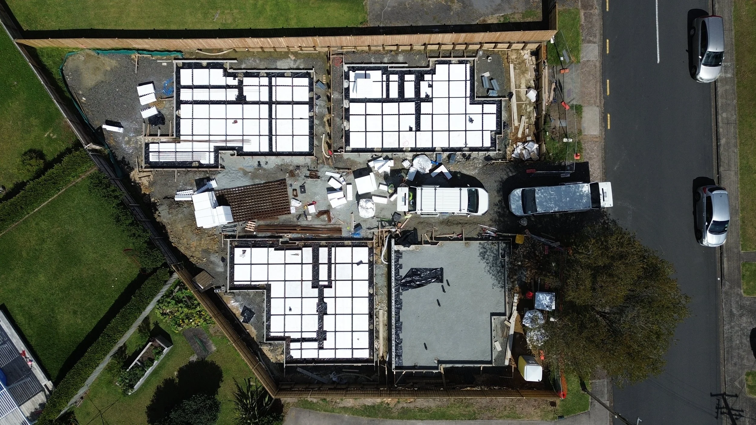 Auckland residential foundation construction project showing an expansive RibRaft system with polystyrene pods and steel mesh reinforcement, ready for concrete pouring.